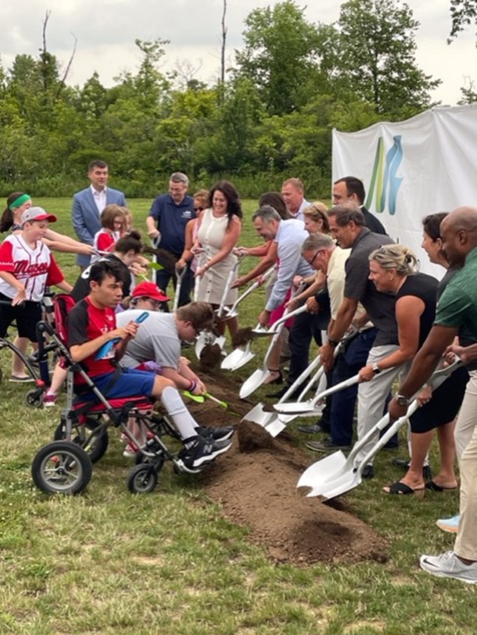 Local, county and state representatives join players and others turn the first shovels of dirt at the Adaptive Ball Fields at Makino Park in Mason, which will open in spring 2024. CONTRIBUTED