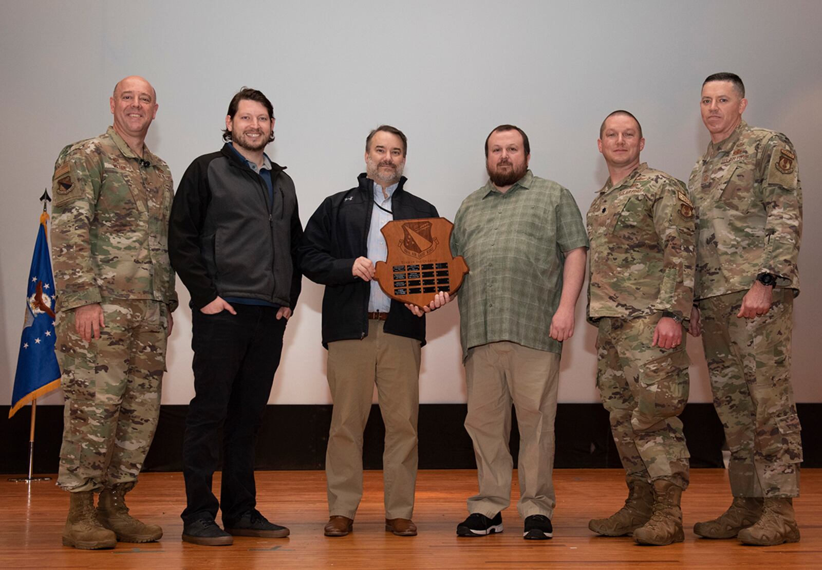 Col. Patrick Miller, 88th Air Base Wing and installation commander, and Chief Master Sgt. Jason Shaffer, 88th ABW command chief, present the MDT Red Hawk team with an award on May 4. MDT Red Hawk was selected as the 88th Air Base Wing small team winner for the first quarter. U.S. AIR FORCE PHOTO/JAIMA FOGG