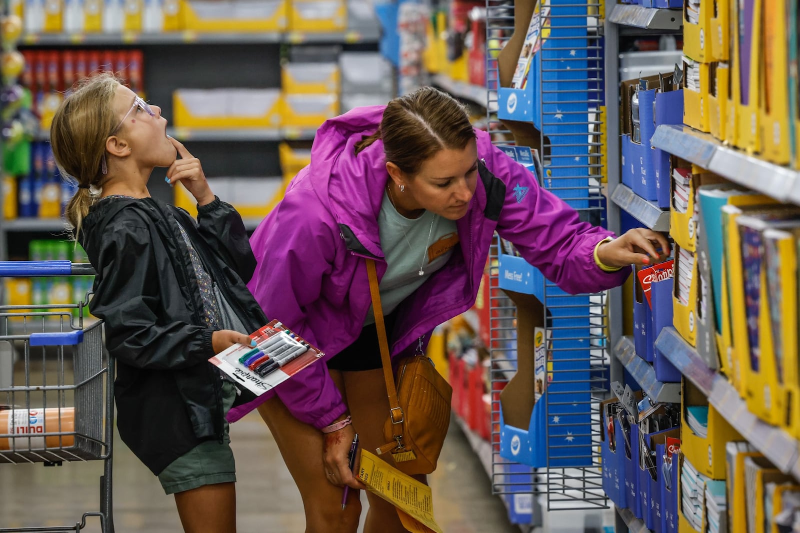 Kate Mossop and her 7-year-old daughter shop for school supplies at the Super Walmart on Wilmington Pike Thursday July 28, 2022. Ohio’s sales tax holiday on school supplies, instructional material and clothes runs from noon Aug. 5 to 11:59 p.m. Aug. 7. Exempt from sales and use tax during the holiday are items of clothing priced at $75 or less, items of school supplies priced at $20 or less and items of school instructional material priced at $20 or less. JIM NOELKER/STAFF