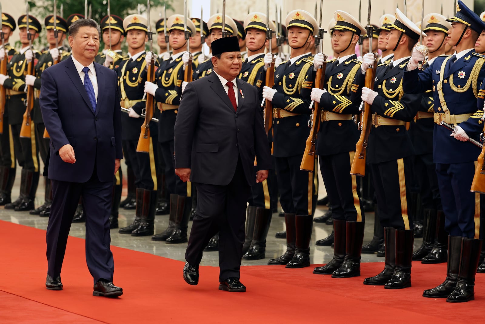 Chinese President Xi Jinping, left, and Indonesia's President Prabowo Subianto review the honour guard during a welcome ceremony at the Great Hall of the People in Beijing, China, Nov. 9, 2024. (Florence Lo/Pool Photo via AP)