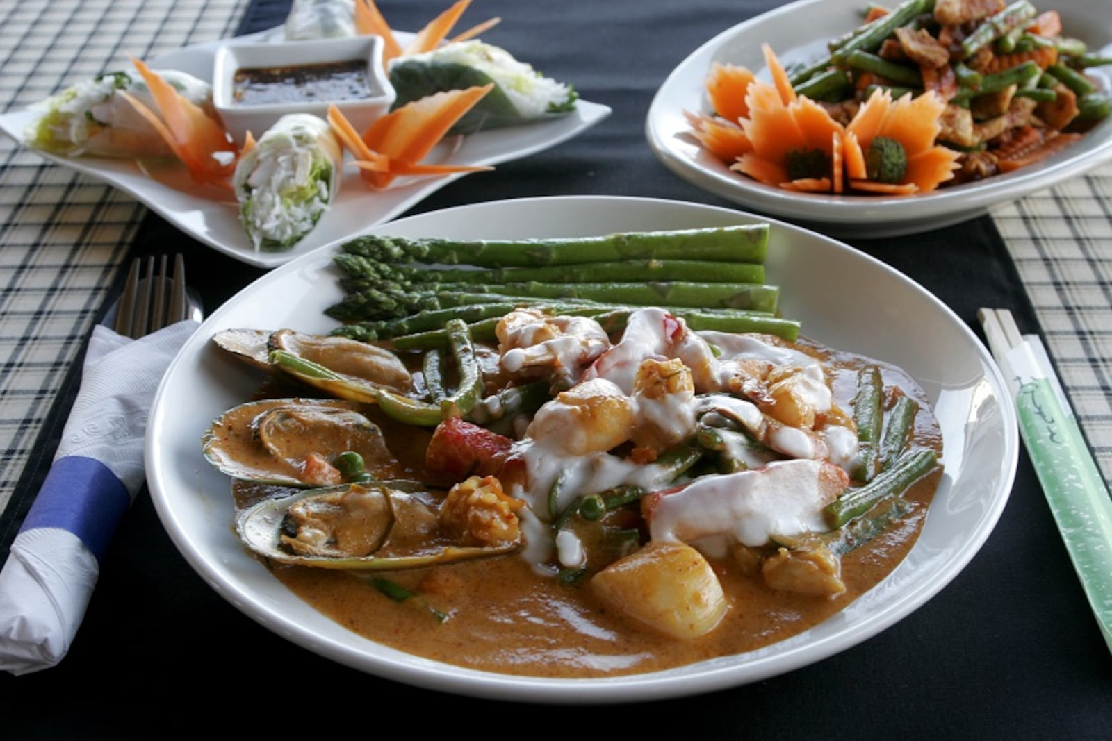 Siam Pad Thai's Panang Curry with Seafood, (clockwise from front)  the Soft Roll, and Chicken Spicy Green Bean. 2009 file photo by Jan Underwood