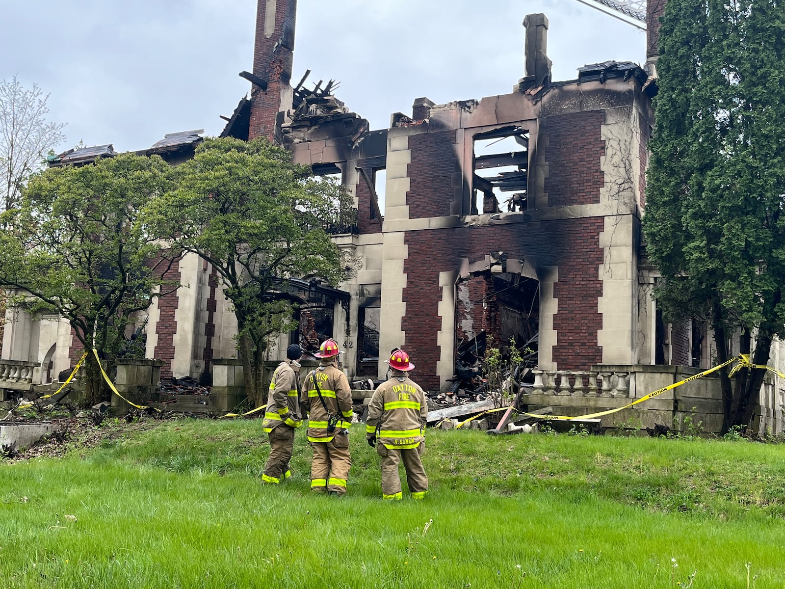 Dayton Fire Department crews assess the scene of the Traxler Mansion fire after extinguishing the blaze at the corner of Broadway and Yale in West Dayton on Sunday, April 23, 2023. JEREMY P. KELLEY / STAFF