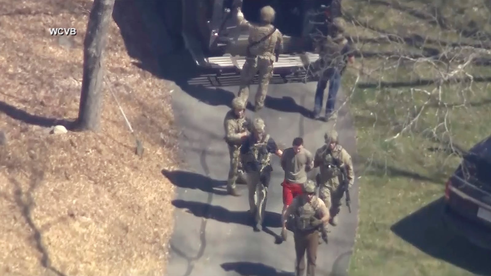 FILE - In this image from video provided by WCVB-TV, Jack Teixeira, in T-shirt and shorts, is taken into custody by armed tactical agents on Thursday, April 13, 2023, in Dighton, Mass. (WCVB-TV via AP)