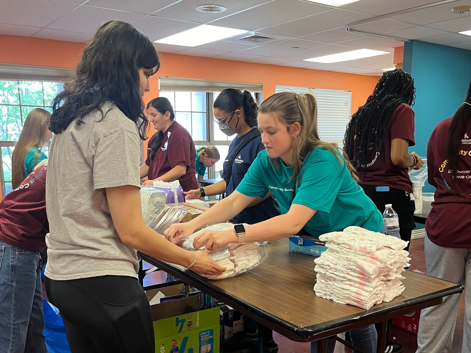 Students from Kettering College of Nursing help wrap and prepare diapers for Dayton Diaper Depot distribution.