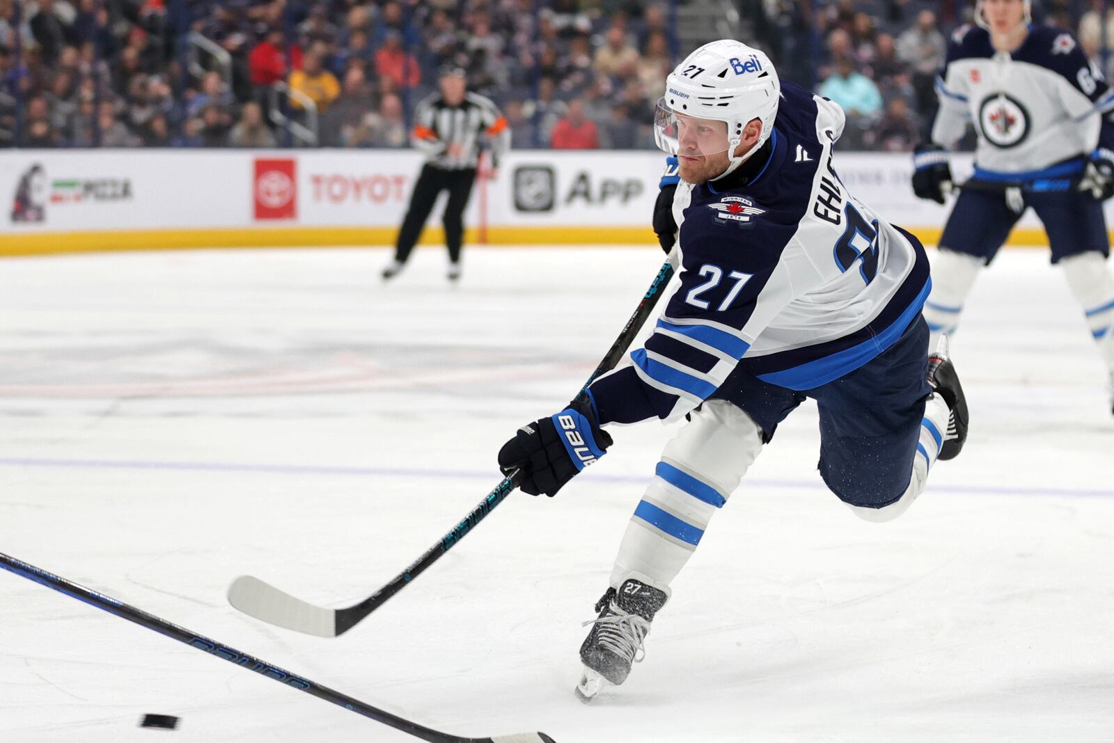 Winnipeg Jets forward Nikolaj Ehlers, right, shoots the puck against the Columbus Blue Jackets during the first period of an NHL hockey game in Columbus, Ohio, Friday, Nov. 1, 2024. Ehlers scored on the play. (AP Photo/Paul Vernon)