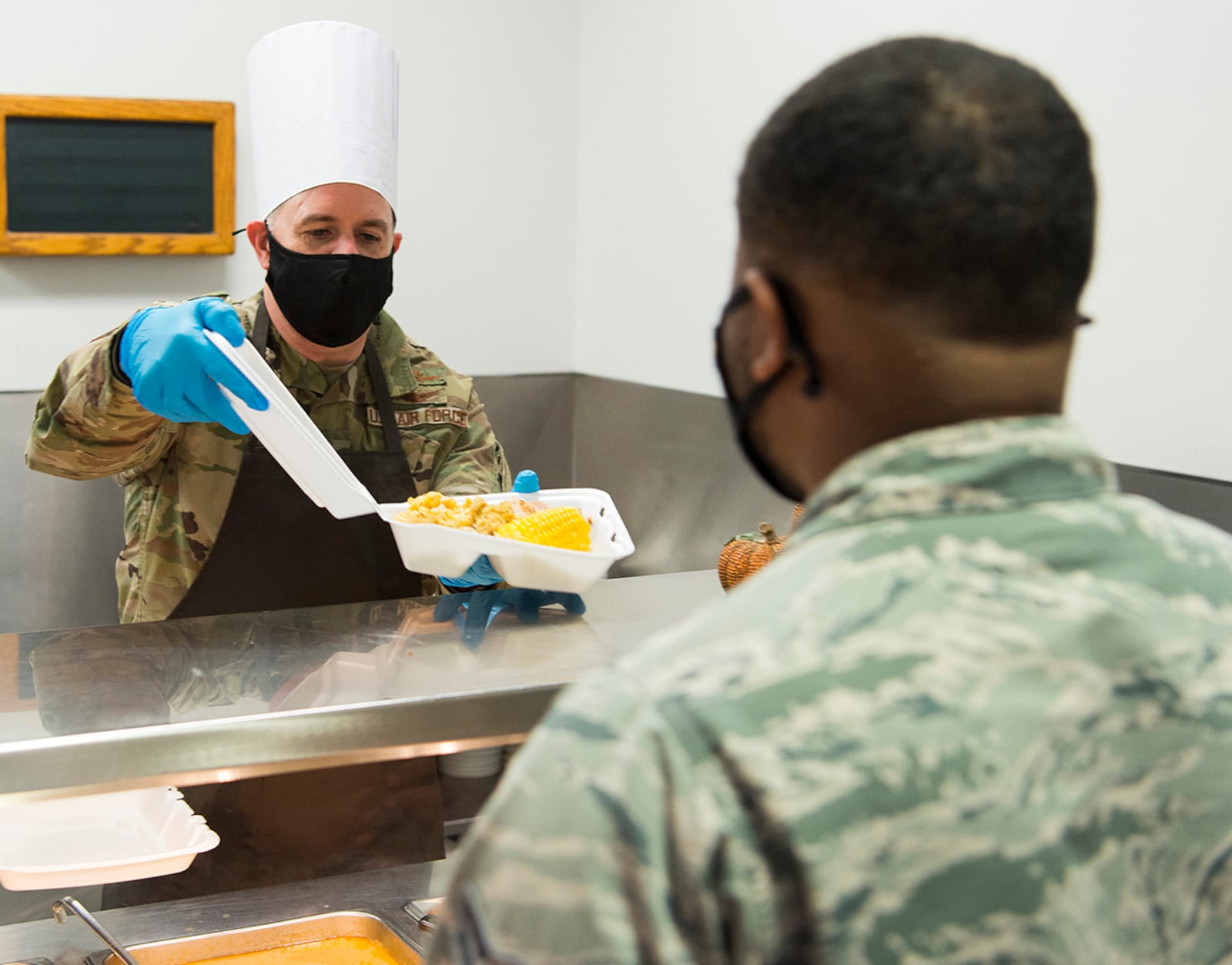 Col. Michael Phillips, 88th Air Base Wing vice commander, hands Airman 1st Class Dantaydin Mitchell, 88th Medical Support Squadron, a turkey dinner to go. U.S. AIR FORCE PHOTO/R.J. ORIEZ