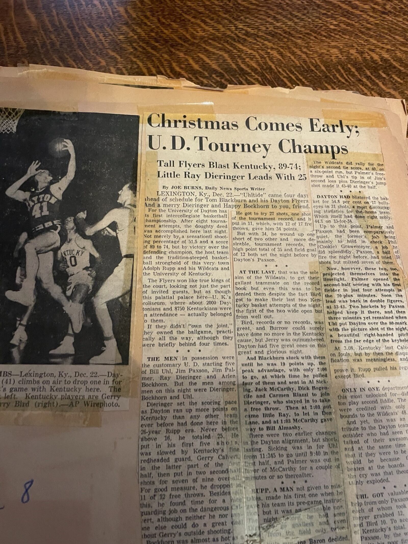 Taped in the scrapbook then 8-year-old Mike DeWine kept of the 1955-56 Dayton Flyers season, a  December 1955 Dayton Daily News article about the No. 4 ranked Flyers winning the University of Kentucky Invitational Tournament. UD first beat No. 3 ranked Utah and then pushed aside the No. 9 ranked Kentucky Wildcats coached by Adolph Rupp. Contributed photo by Mike DeWine