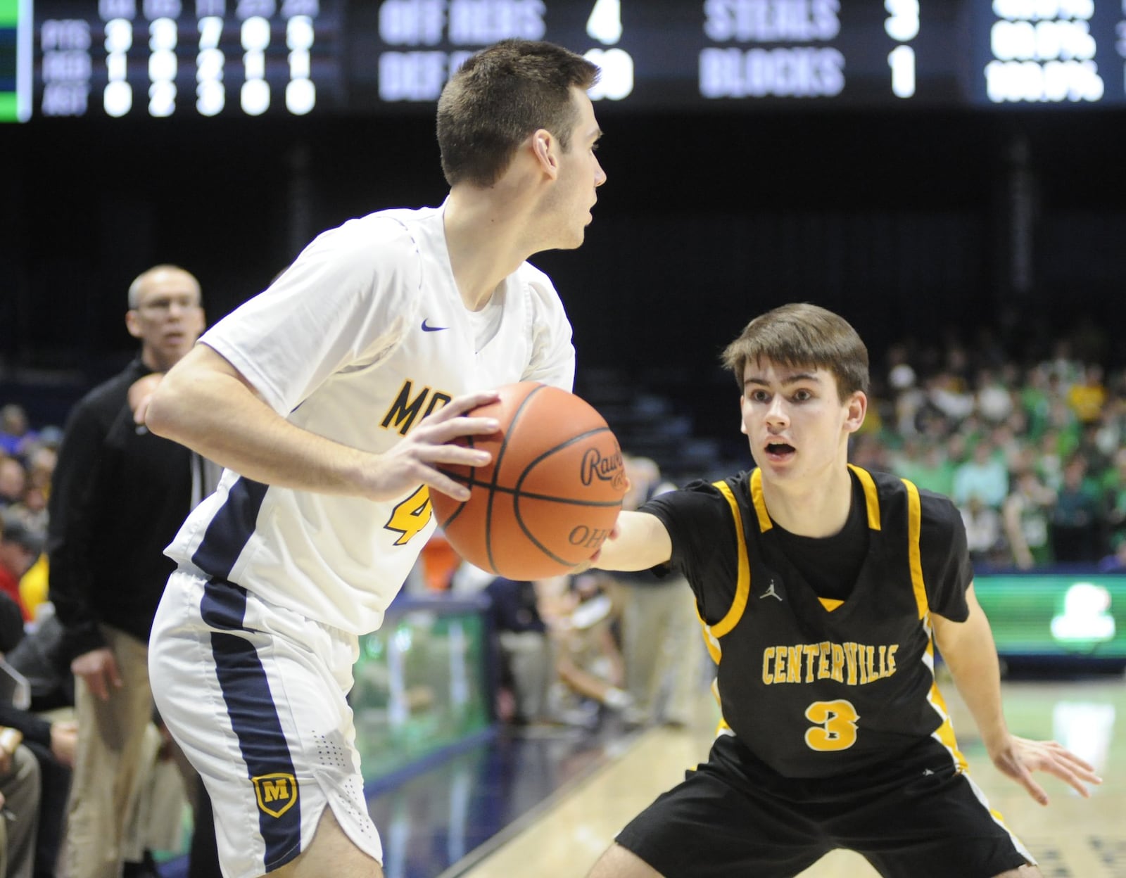 Matt Pearce of Centerville (3) gets defensive with Michael Shipp. Moeller defeated Centerville 59-41 in a boys high school basketball D-I regional final at Xavier University’s Cintas Center on Saturday, March 16, 2019. MARC PENDLETON / STAFF