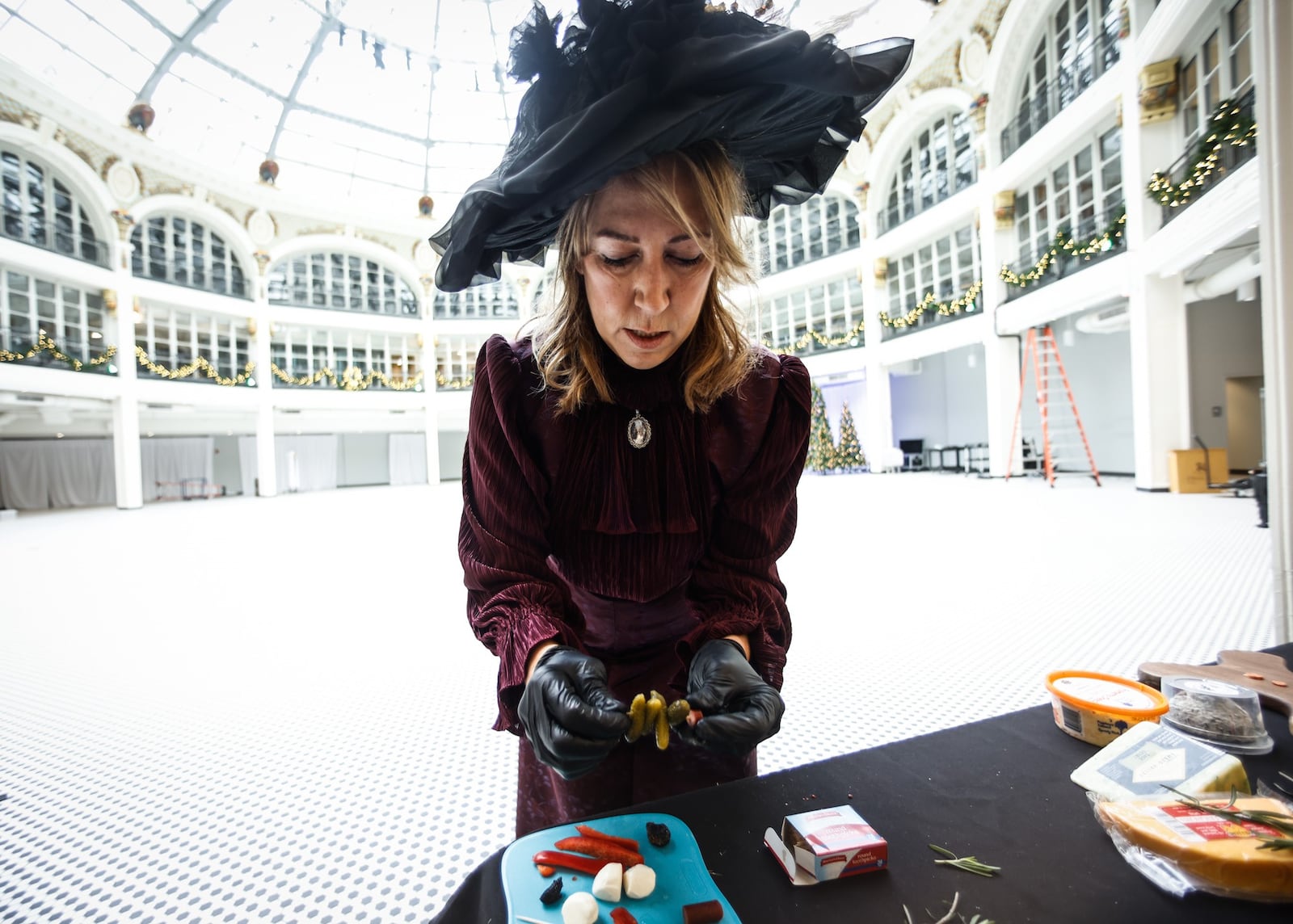 Annie Foos, owner of Saint Anne's Cheese Company, dresses as Ruth Disher Dayton's first cheese lady at the Dayton Arcade. Holly Days are returning to the Dayton Arcade this week. This year’s three-day event, organized by Cross Street Partners and Culture Works, will bring back some of the same nostalgia that powered the past Holly Days. JIM NOELKER/STAFF