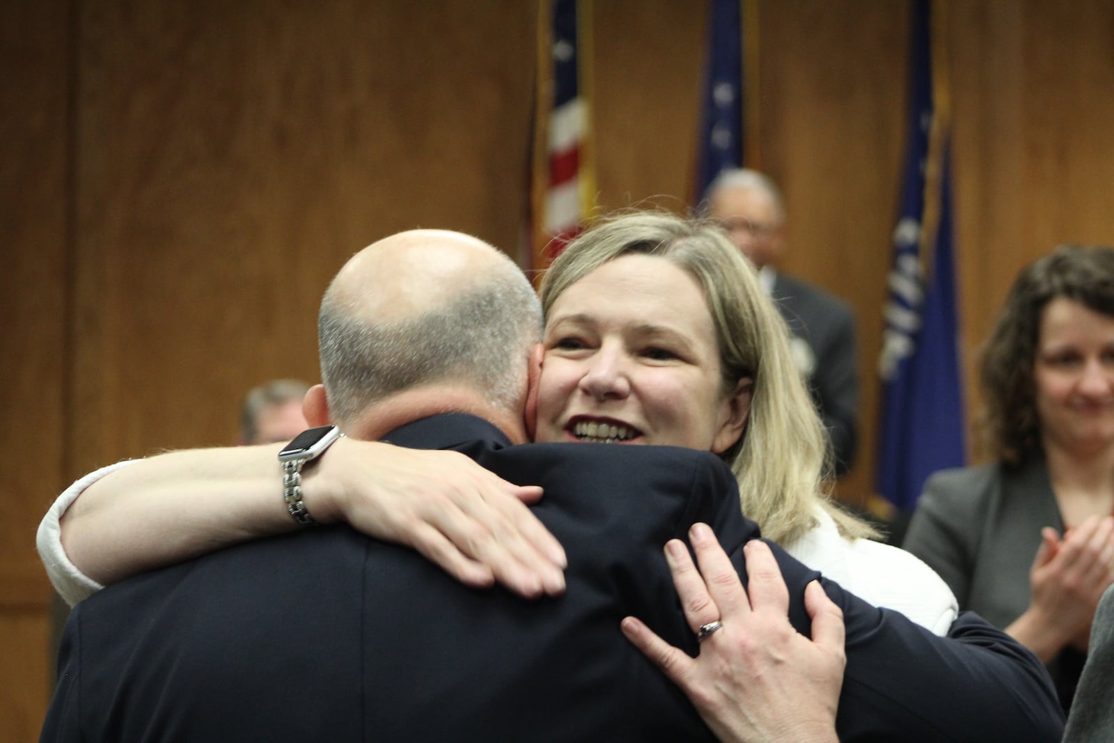 Dayton Mayor Nan Whaley on Wednesday hugs Health Commissioner Jeff Cooper during the city commission's first in-person meeting in 15 months. Whaley presented Keys to the City to Cooper and two other officials with Public Health -- Dayton & Montgomery County. CORNELIUS FROLIK / STAFF