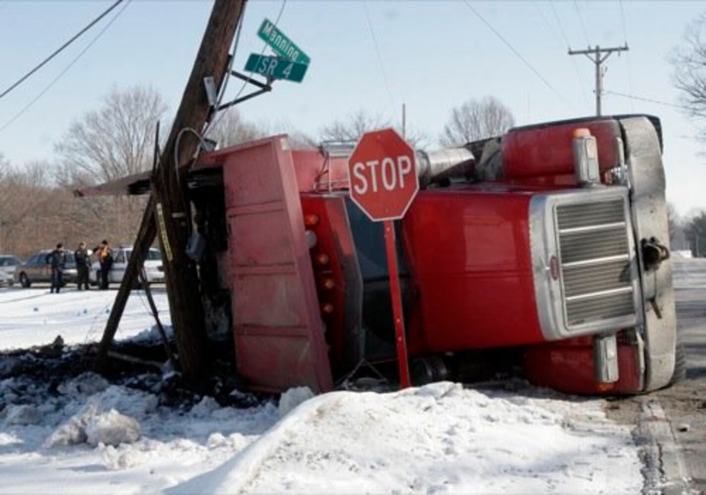 Dump truck flips onto its side