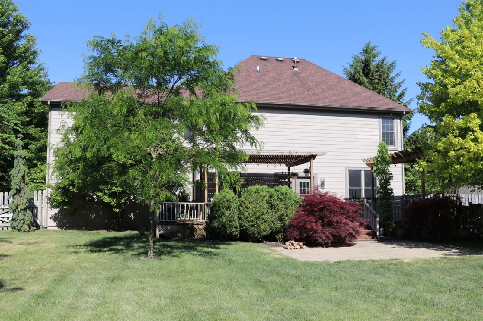 Most of the property is surrounded by a wooden privacy fence, creating the park-like backyard setting. 