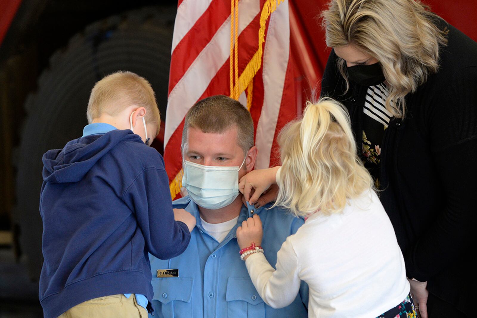 Lt. Chad Engman, an Air Force firefighter with the 788th Civil Engineer Squadron, is pinned on by his children, Cameron and Lexi, and wife, Leah, during a promotion ceremony on March 29 at Wright-Patterson Air Force Base. U.S. AIR FORCE PHOTO/TY GREENLEES