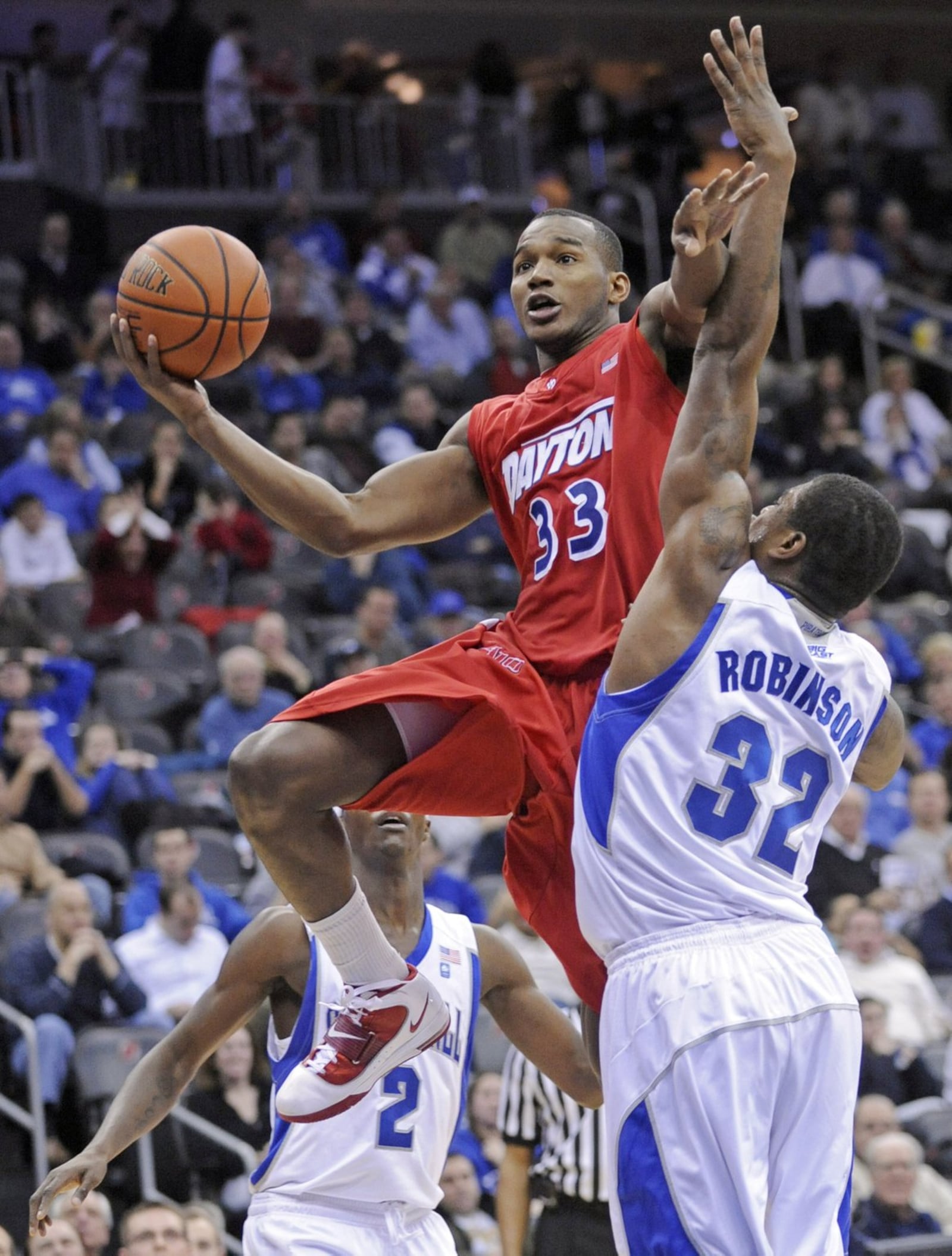 Dayton’s Chris Wright (33) holds off Seton Hall’s Jeff Robinson as he puts up a shot during the second half of an NCAA college basketball game Wednesday, Dec. 22, 2010 in Newark, N.J. (AP Photo/Bill Kostroun)