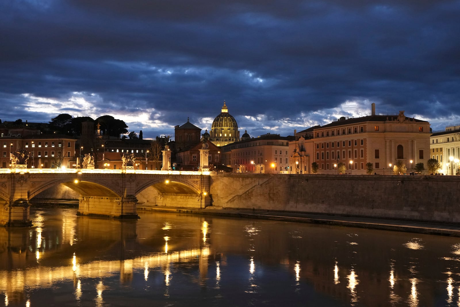 Dark clouds hover over St Peter's Basilica at the Vatican in Rome, Sunday, March 2, 2025. (AP Photo/Kirsty Wigglesworth)