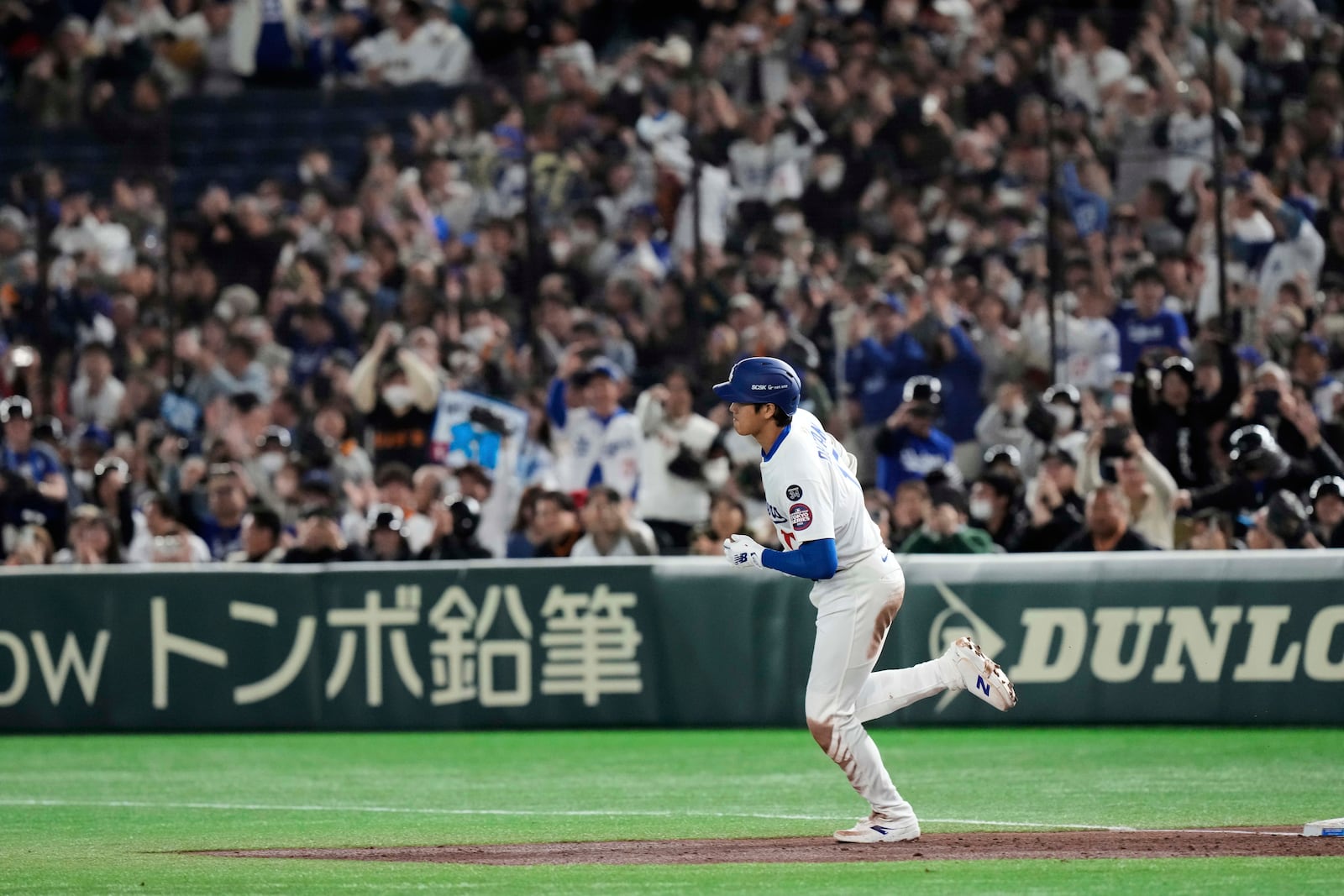 Los Angeles Dodgers' Shohei Ohtani rounds the bases after hitting a two-run home run in the third inning of a spring training baseball game against the Yomiuri Giants in Tokyo, Japan, Saturday, March 15, 2025. (AP Photo/Eugene Hoshiko)