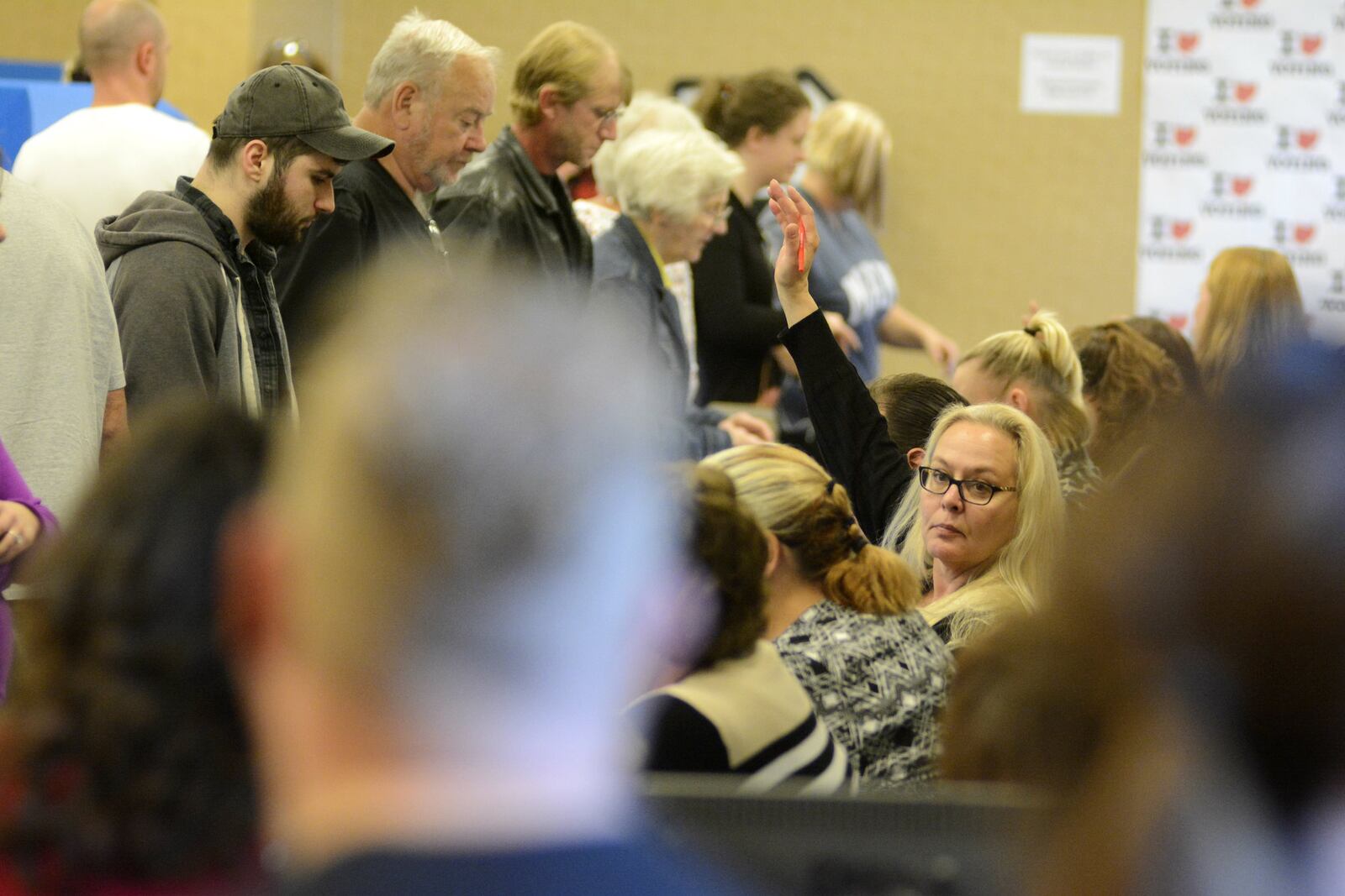 Butler County Board of Elections workers signal to help the next person in line on Monday, Nov. 7, at the elections office in Hamilton. More than 2,400 votes were cast at the elections office on the last day of early voting. MICHAEL D. PITMAN/STAFF