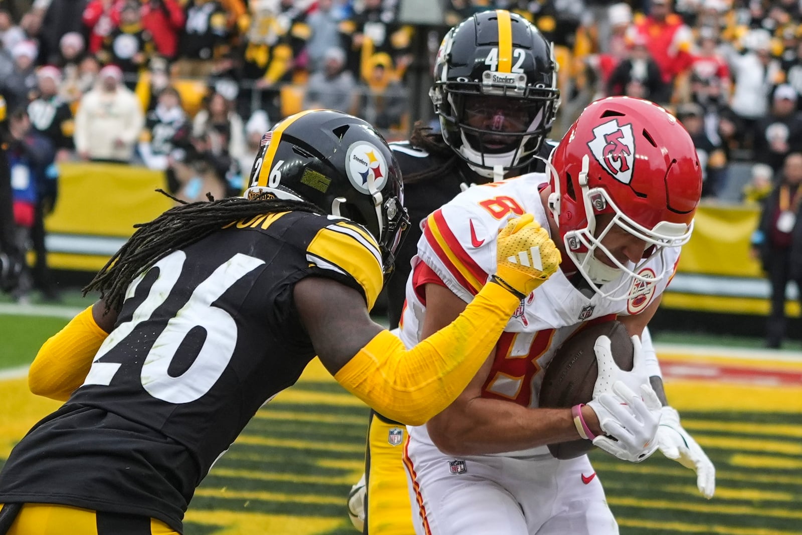 Kansas City Chiefs wide receiver Justin Watson (84) scores a touchdown against Pittsburgh Steelers cornerback Donte Jackson (26) during the first half of an NFL football game, Wednesday, Dec. 25, 2024, in Pittsburgh. (AP Photo/Gene J. Puskar)