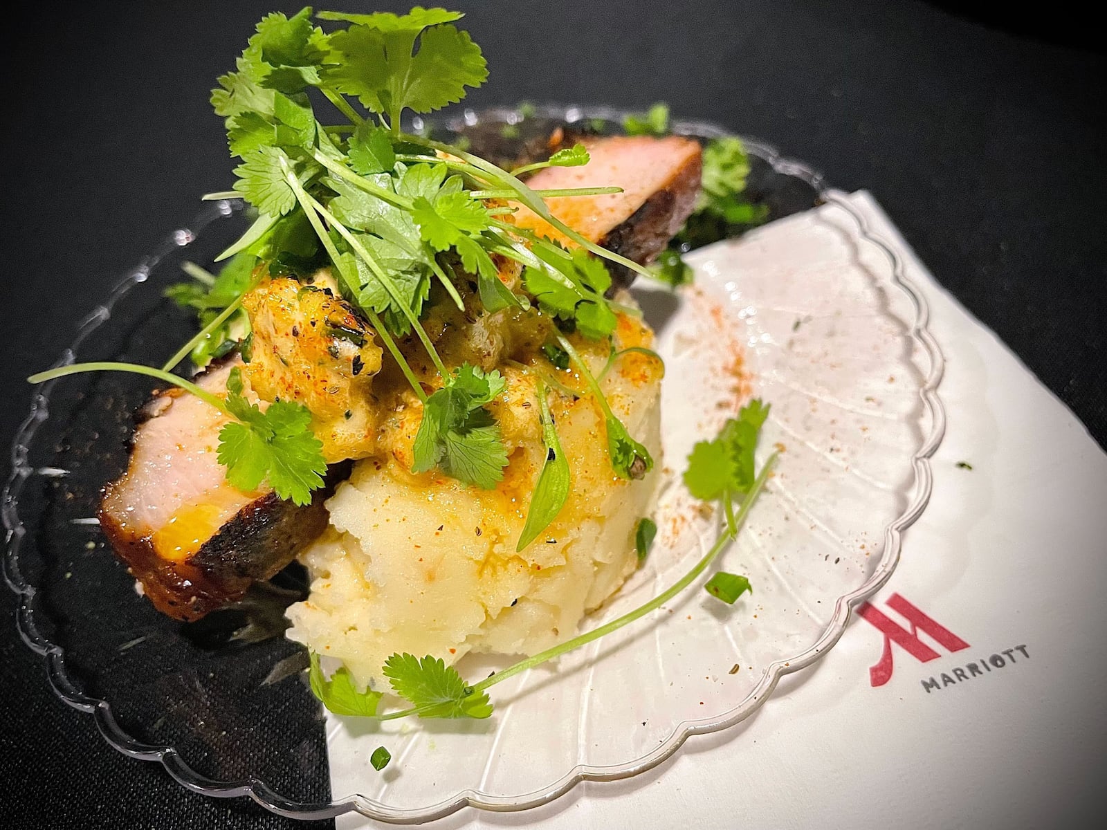 Sneak Peek to Winter Restaurant Week at the Steam Plant on Jan. 22, 2025 featured samples from 12 restaurants in the Dayton region. Pictured is a grilled beer, marinated pork chop and mashed potatoes from Dewberry 1850. NATALIE JONES/STAFF