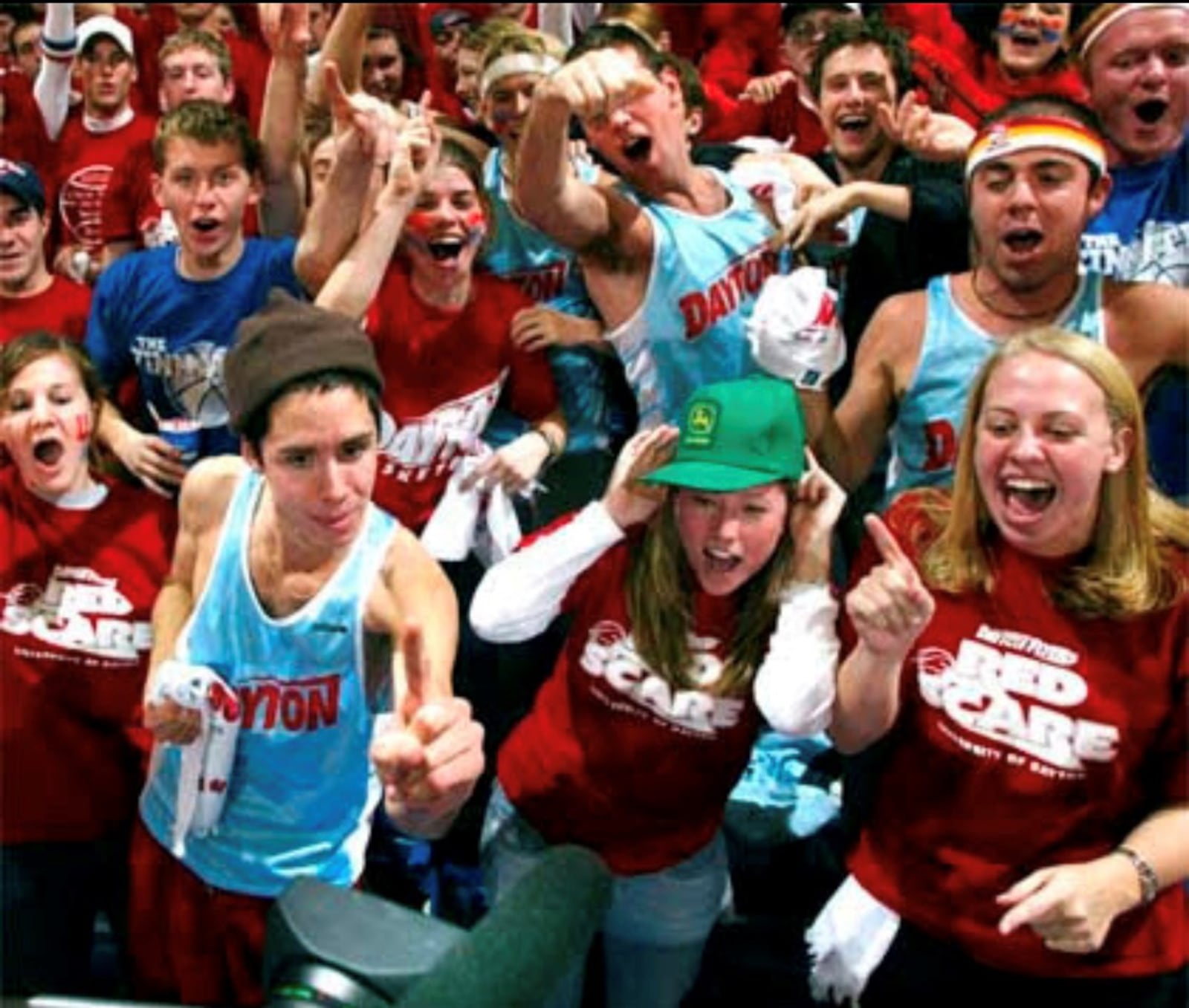 Members of the 2003 Dayton Flyers cross country team show off their old Chapel Blue uniforms in the Red Scare student section during a basketball game at UD Arena. Contributed photo