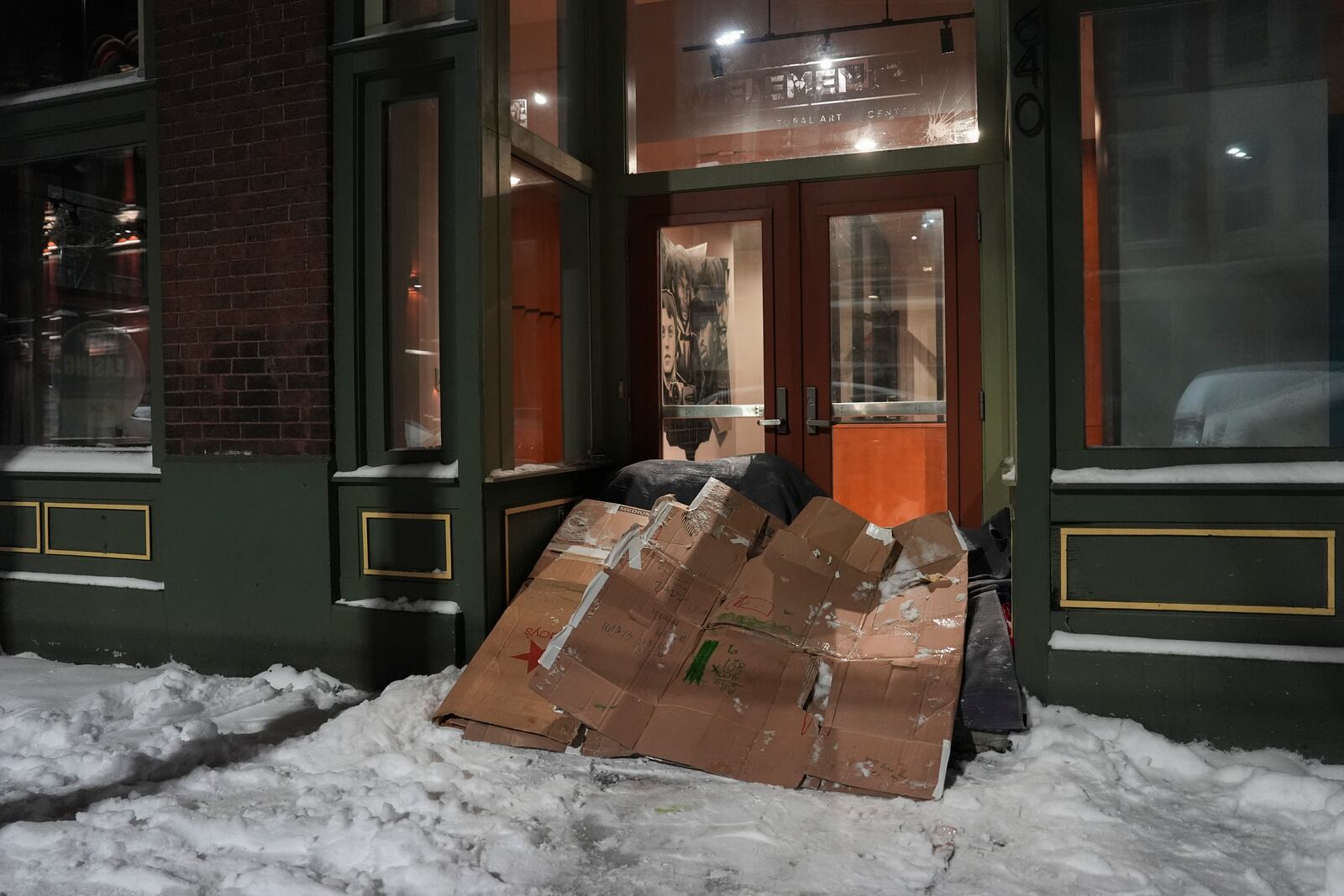 A makeshift shelter sits at the entrance to a building, Tuesday, Jan. 7, 2025, in Cincinnati. (AP Photo/Joshua A. Bickel)