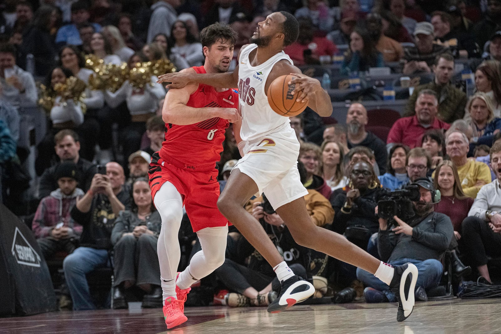 Portland Trail Blazers' Deni Avdija (8) blocks Cleveland Cavaliers' Evan Mobley, right, during the first half of an NBA basketball game in Cleveland, Sunday, March 2, 2025. (AP Photo/Phil Long)