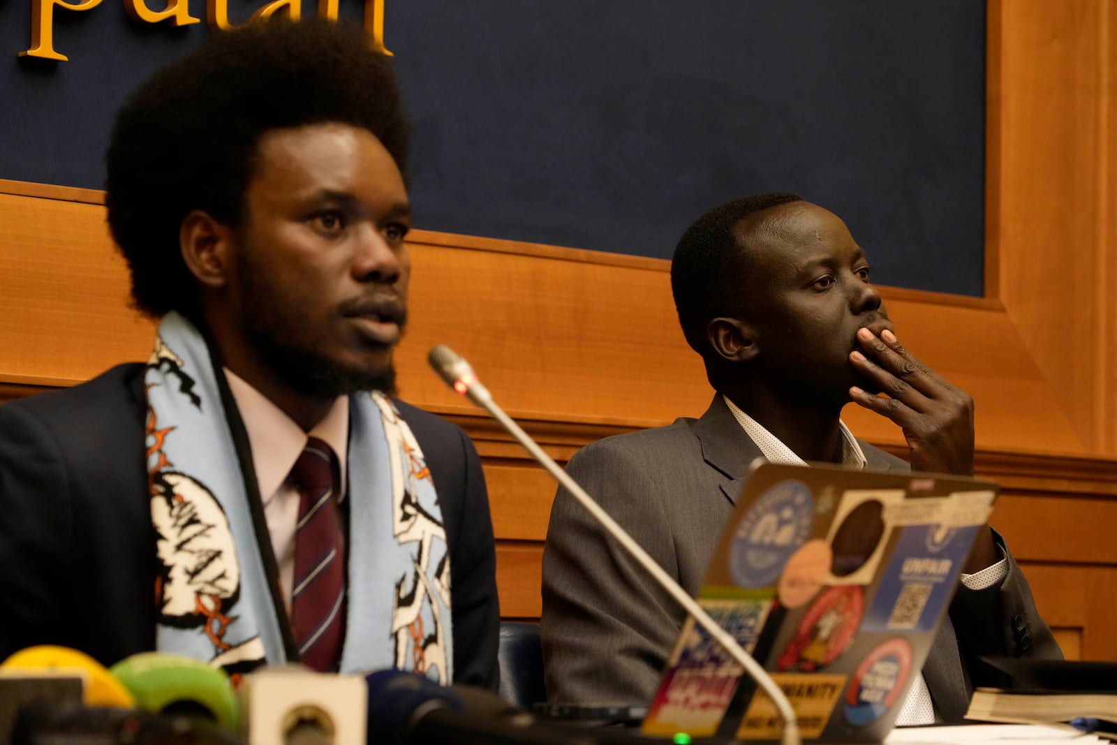 David Yambio, left, and Lam Magok, both from South Sudan meet the journalists during a press conference where they recounted their experience while detained in the Libyan prisons, in Rome, Wednesday, Jan. 29, 2025. (AP Photo/Gregorio Borgia)