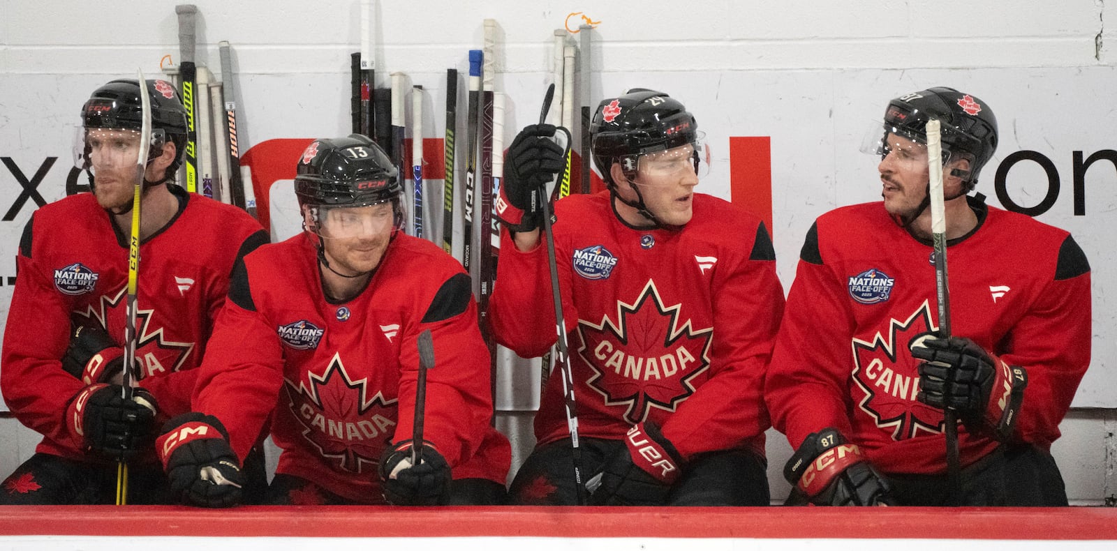 Canada players, from left, Connor McDavid, Sam Reinhart, Nathan MacKinnon and Sidney Crosby talk on the bench during 4 Nations Face-Off hockey practice in Montreal on Monday, Feb. 10, 2025. Canada will face Sweden on Feb. 12. (Christinne Muschi/The Canadian Press via AP)