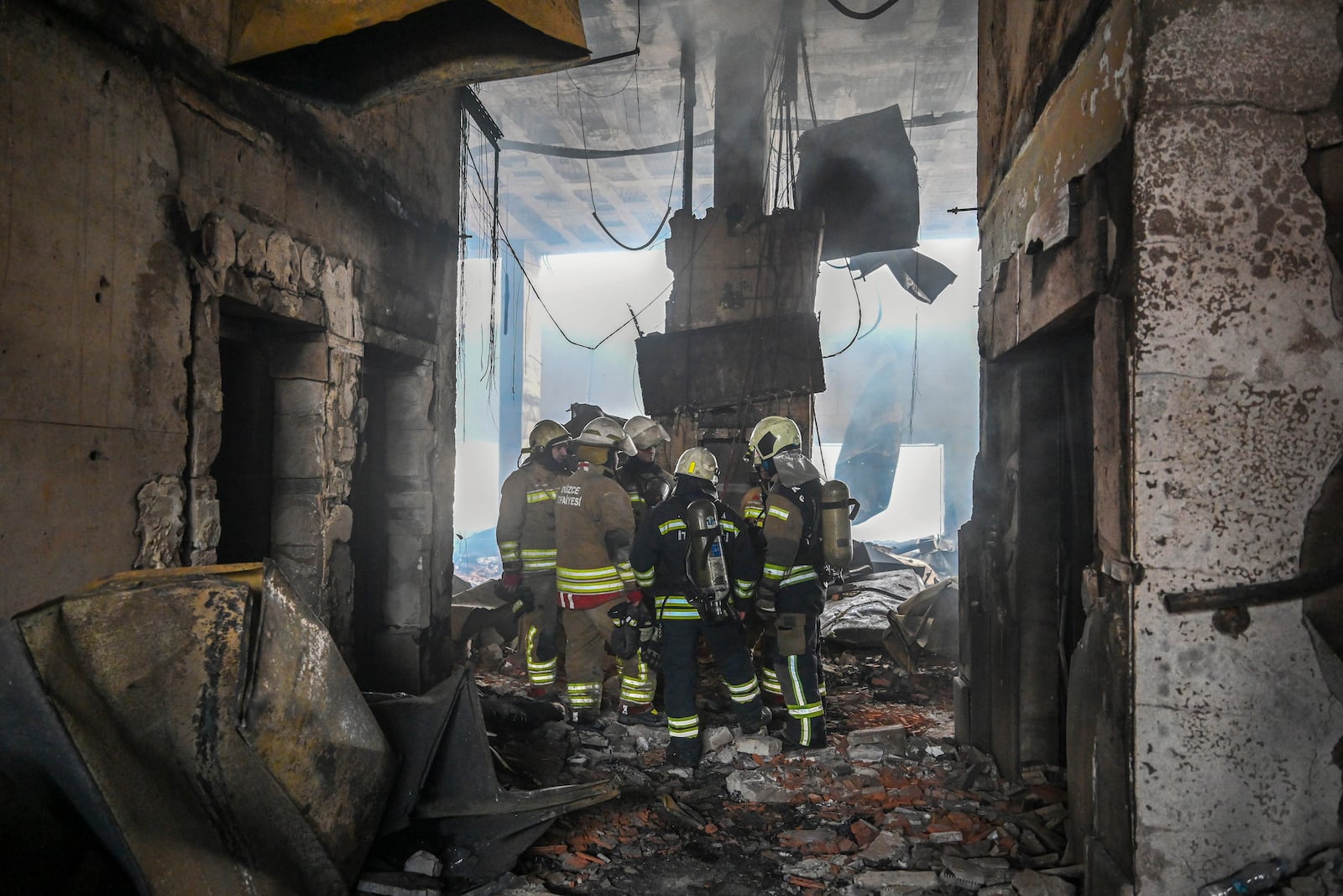 Firefighters work at the scene after a fire broke out at a hotel in the ski resort of Kartalkaya, located in the Bolu province, northwest Turkey, Tuesday, Jan. 21, 2025. (Mert Gokhan Koc/dia Photo via AP)