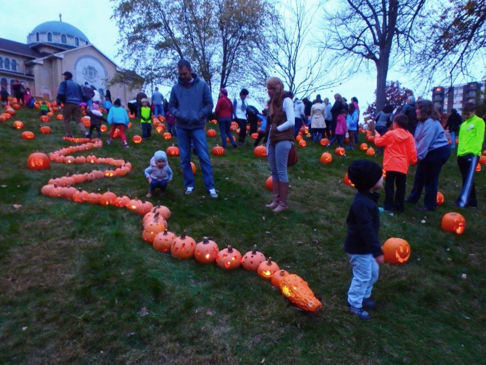 Cutline: Approximately 800 uniquely carved jack'o-lanterns on the hill behind the Greek Orthodox Church in the historic Grafton Hill neighborhood attracted hundreds of visitors Friday, Oct. 30. The Pumpkin Glow continues on Saturday evening, Oct. 31.