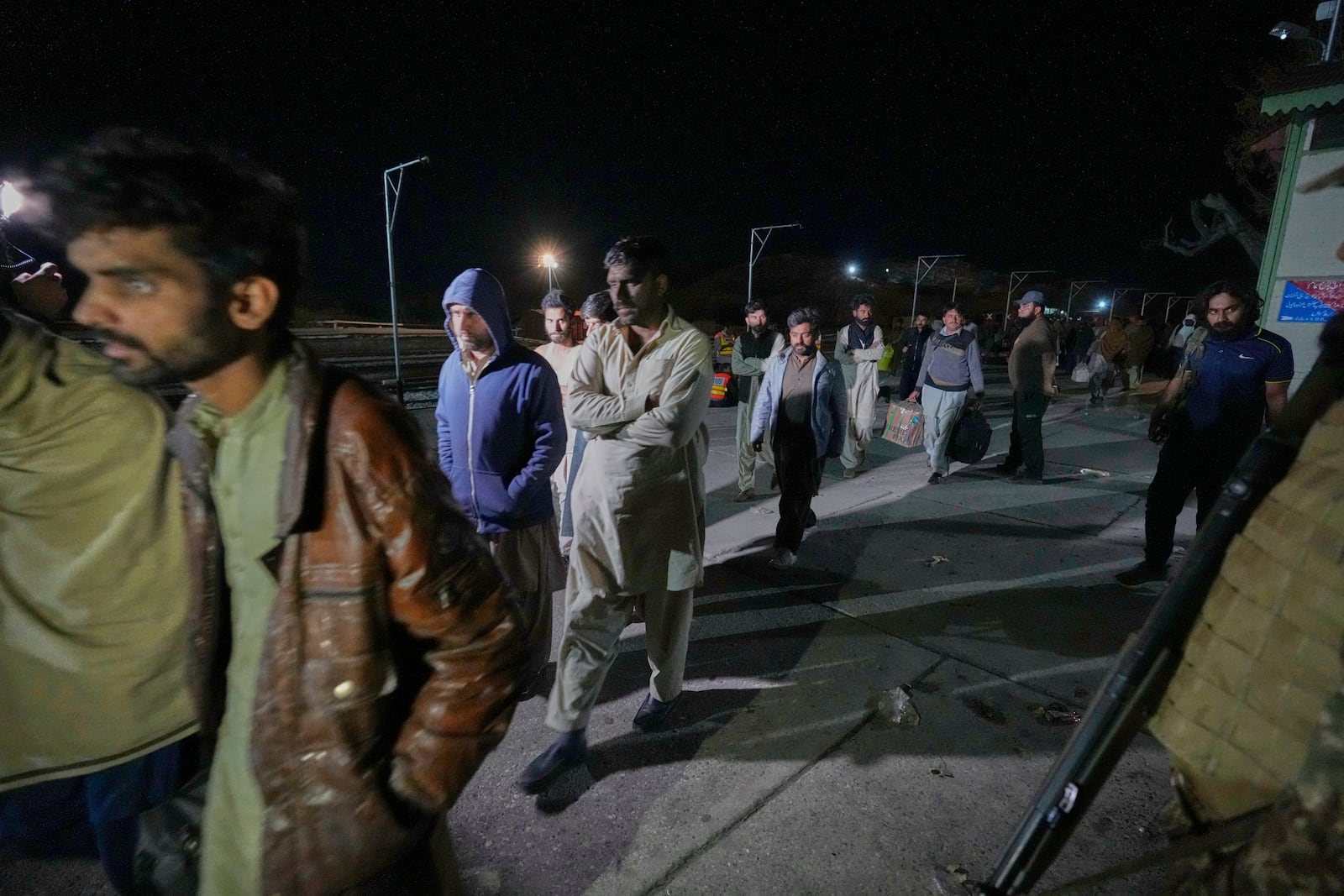 Passengers rescued by security forces from a passenger train attacked by insurgents arrive at a railway station in Much, Pakistan's southwestern Balochistan province, Thursday March 13, 2025. (AP Photo/Anjum Naveed)