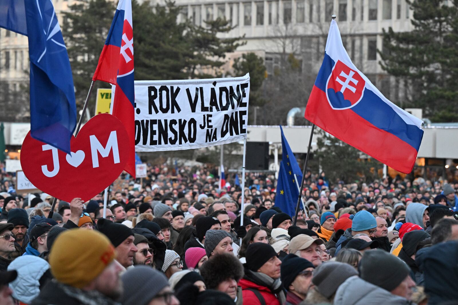 People gather in Bratislava, Slovakia on Friday Feb. 21, 2025, to mark the seventh anniversary of the slayings of an investigative journalist and his fiancee, Jan Kuciak and Martina Kusnirova. (Vaclav Salek/CTK via AP)