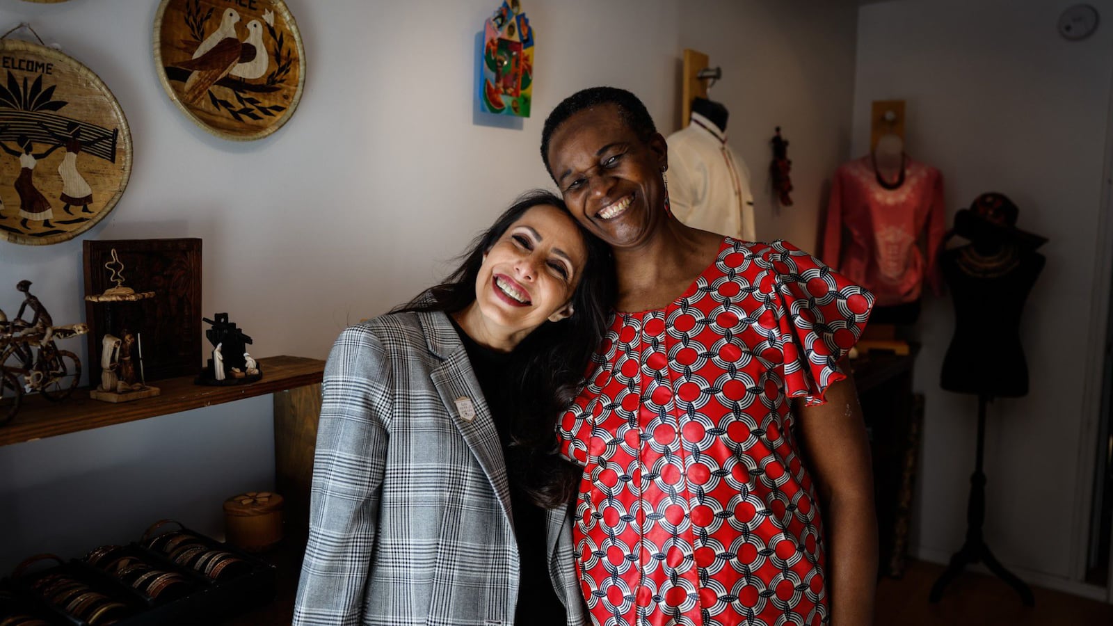 Gabriela Pickett, left and Severa Mwiza co-owns La Viva Rwanda, a fair trade store in Dayton. Pickett is a Mexican immigrant and Mwiza is a Rwandan immigrant. JIM NOELKER/STAFF