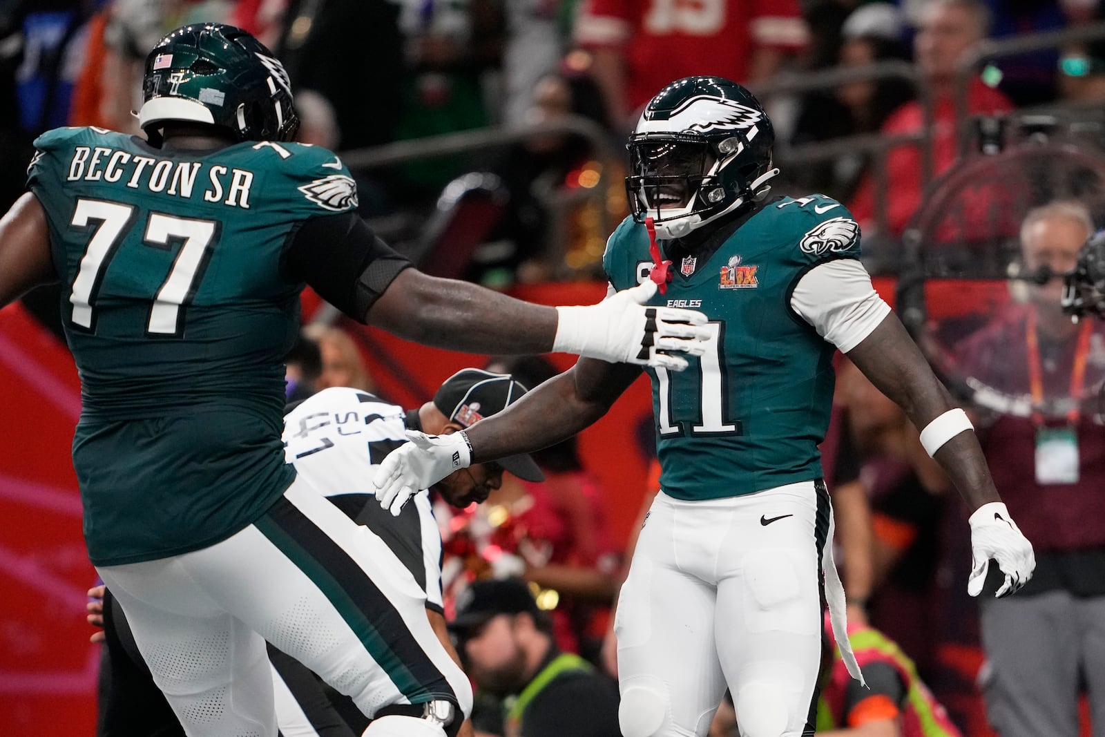 Philadelphia Eagles wide receiver A.J. Brown (11) is congratulated by teammate Mekhi Becton (77) after catching a touchdown pass during the first half of the NFL Super Bowl 59 football game against the Kansas City Chiefs, Sunday, Feb. 9, 2025, in New Orleans. (AP Photo/Doug Benc)