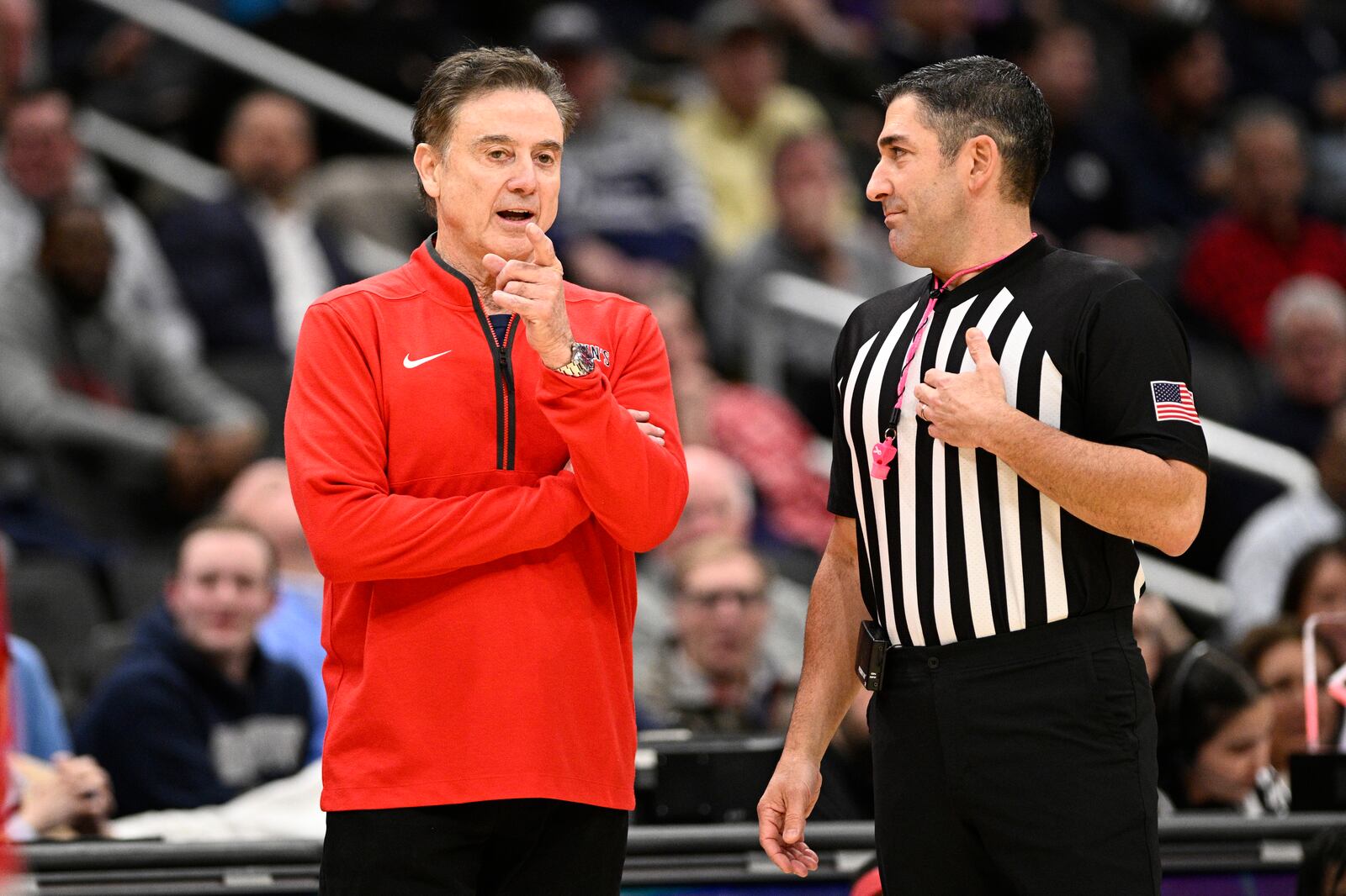 St. John's head coach Rick Pitino, left, talks with an official during the first half of an NCAA college basketball game against Georgetown, Tuesday, Jan. 28, 2025, in Washington. (AP Photo/Nick Wass)