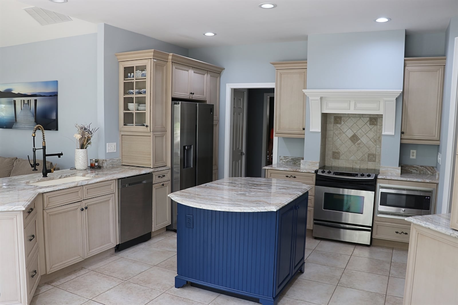 Nearly every available wall space in the kitchen area has cabinetry designed for specific needs. A large island was added with a marble counter and additional storage options. Contributed by Kathy Tyler