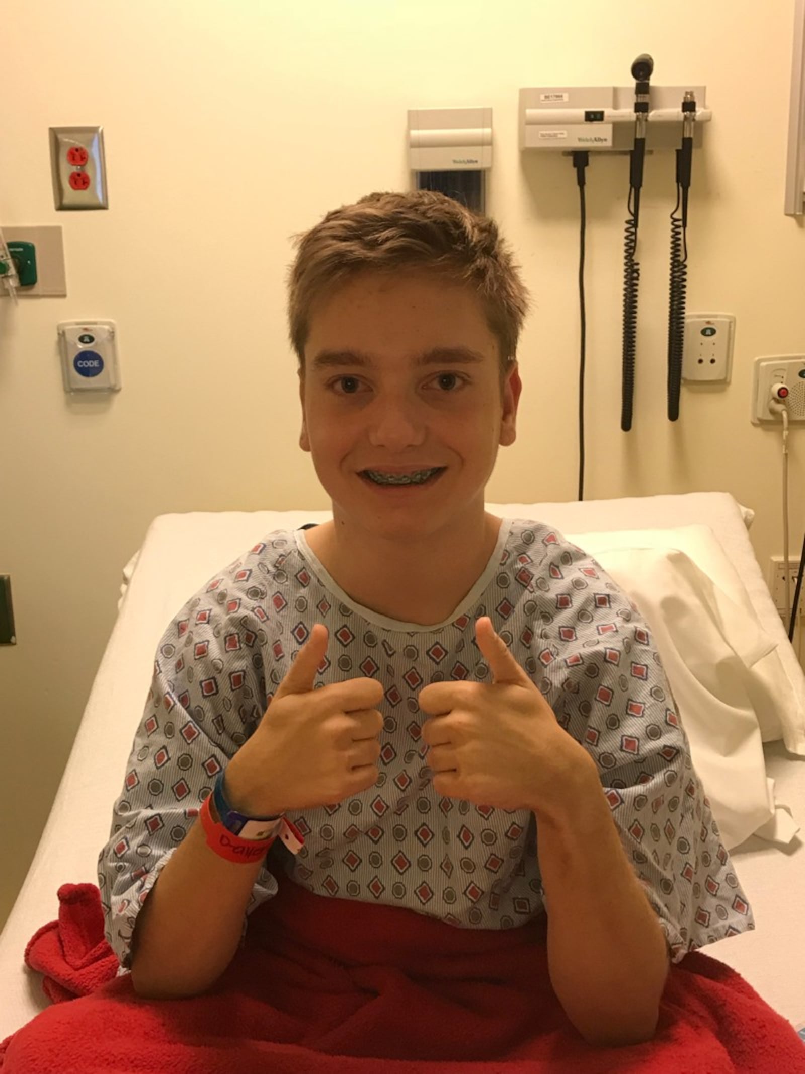 Kaden giving the thumbs up before surgery.