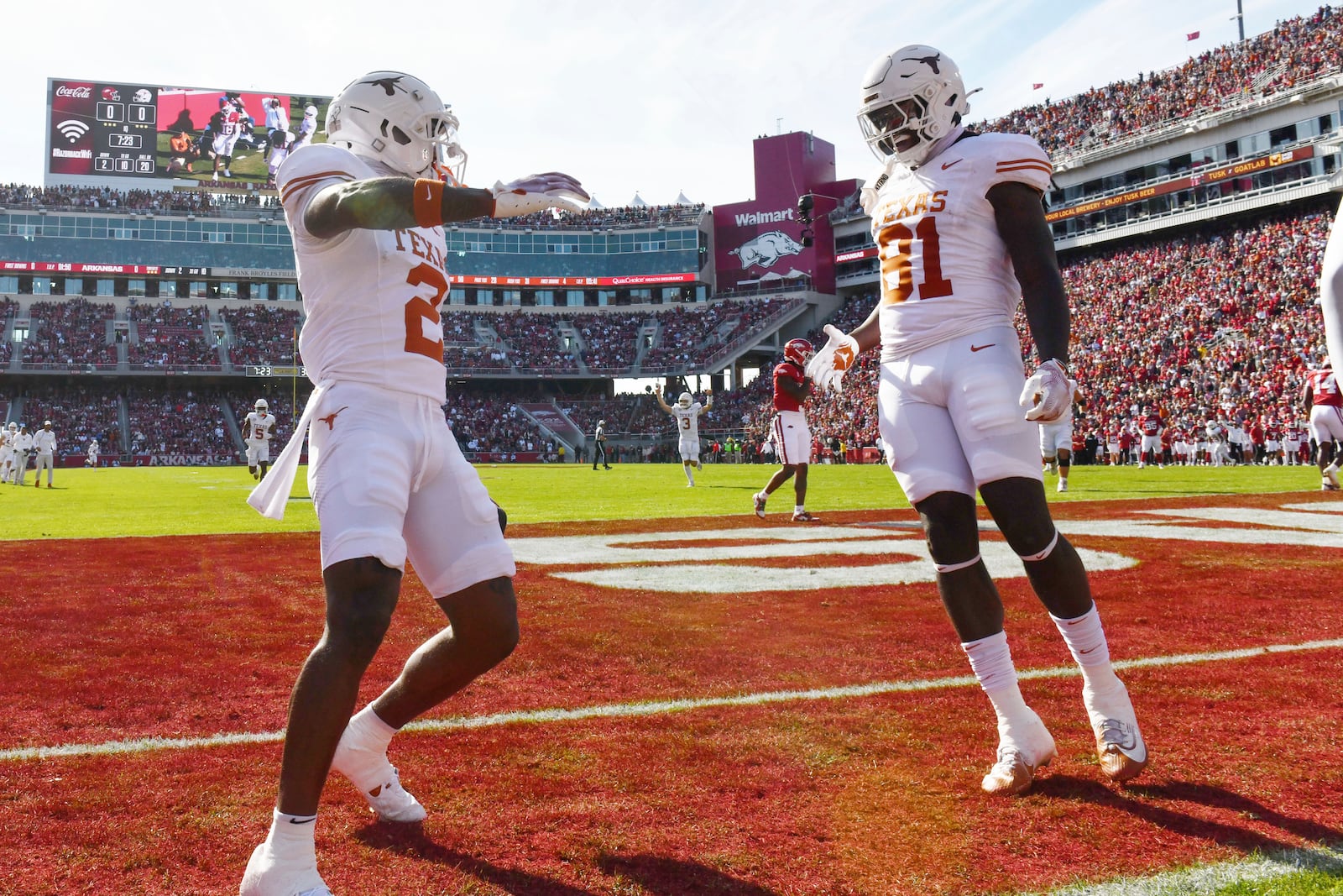 Texas wide receiver Matthew Golden (2) celebrates with teammate Juan Davis (81) after making a touchdown catch against Arkansas during the first half of an NCAA college football game Saturday, Nov. 16, 2024, in Fayetteville, Ark. (AP Photo/Michael Woods)