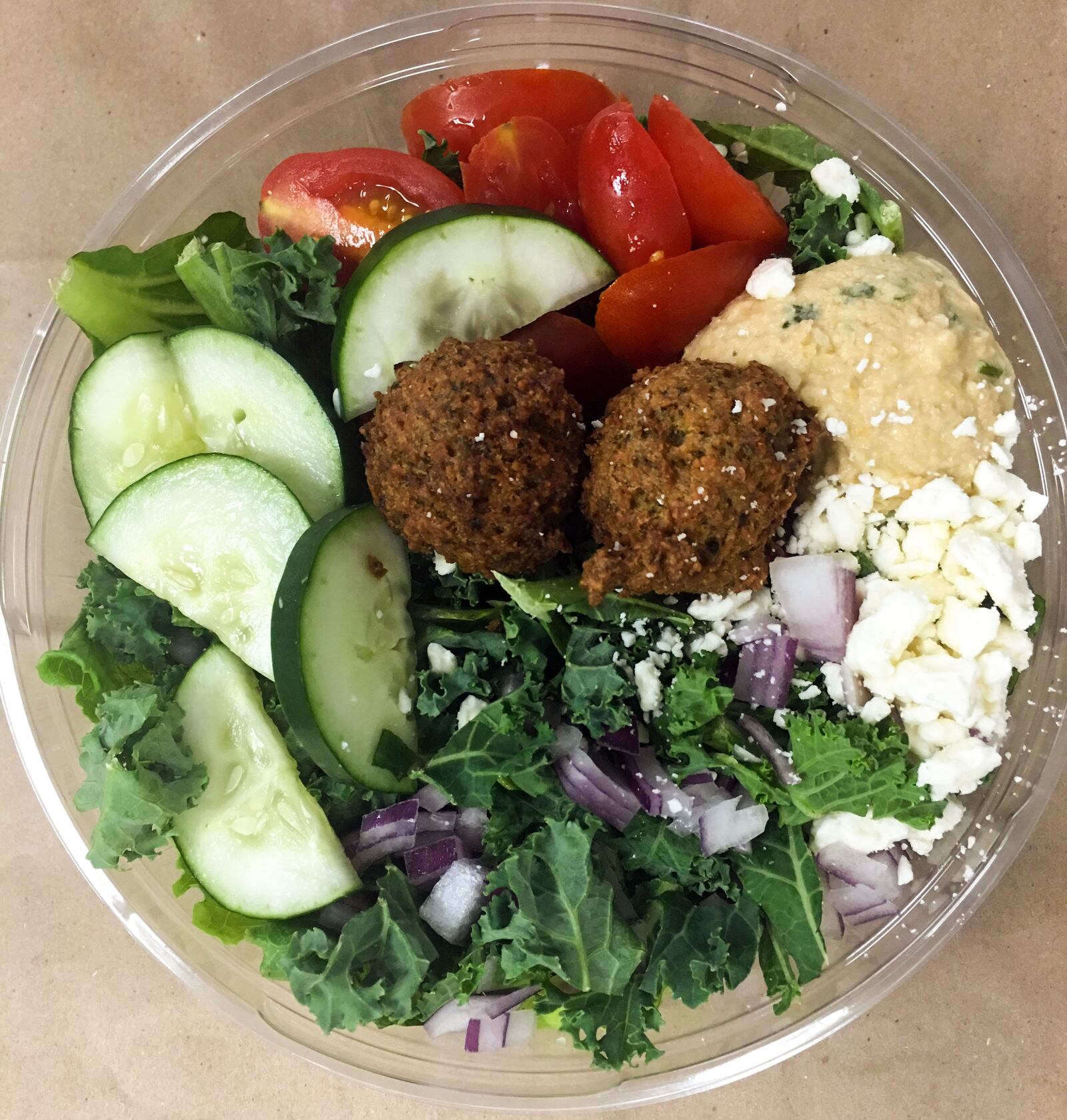 The Mediterranean green bowl from CoreLife Eatery had a shredded kale & chopped romaine base, house-made hummus, house-made falafel, cucumbers, tomatoes, feta, red onion. We tried it with the suggested with cucumber. ASHLEY BETHARD / STAFF