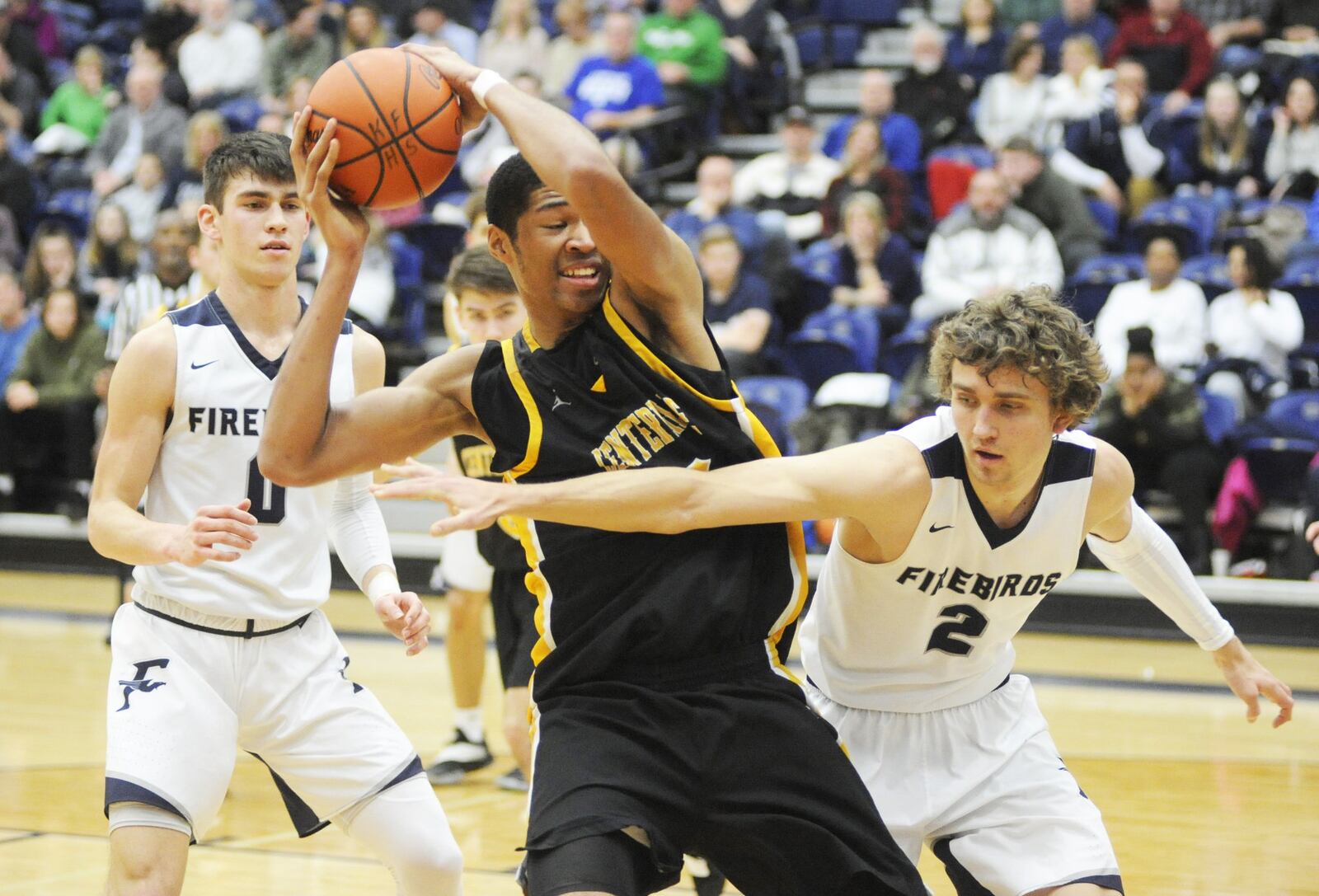 Mo Njie of Centerville (middle) takes a rebound away from Kellan Bochenek of Fairmont. Centerville defeated Fairmont 46-44 in a boys high school basketball game at Trent Arena on Friday, Feb. 8, 2019. MARC PENDLETON / STAFF