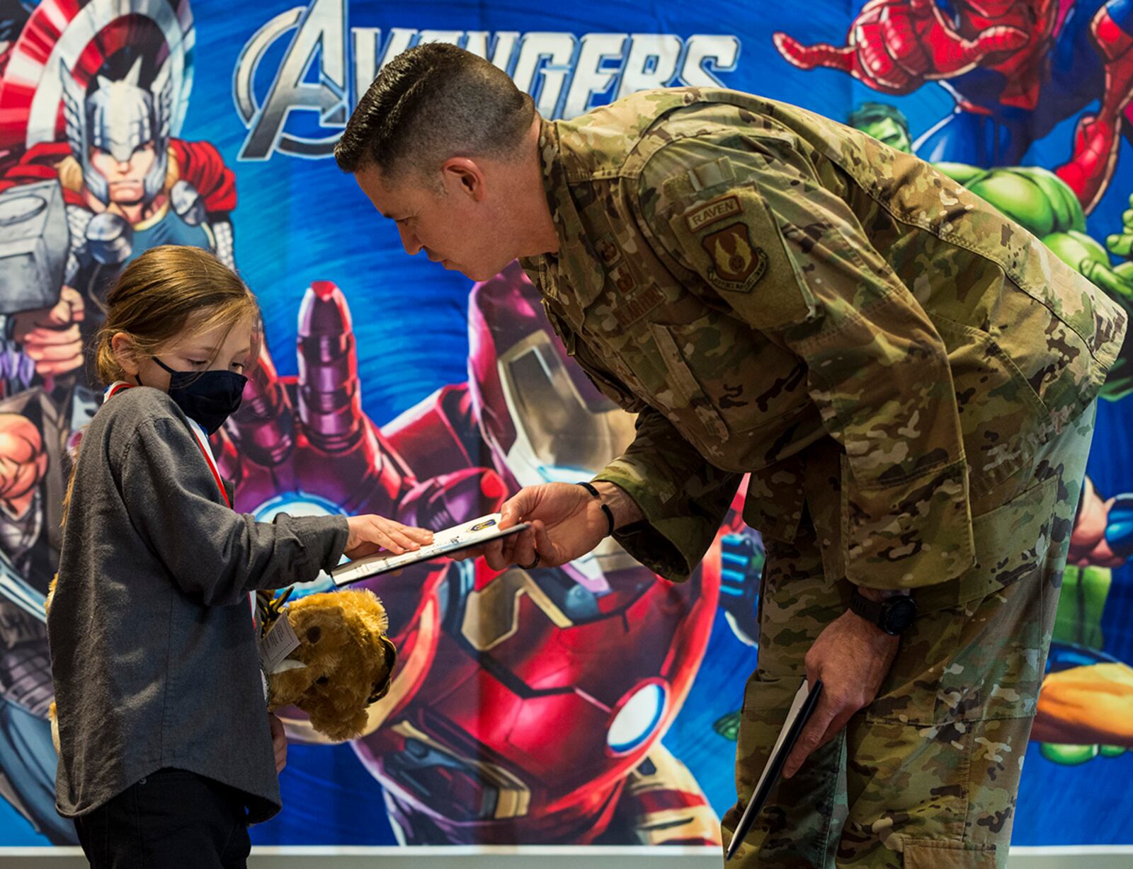 Chief Master Sgt. Jason Schaffer, 88th Air Base Wing command chief, presents a certificate to a child during the “Little Heroes” celebration April 8 at Wright-Patterson Air Force Base. U.S. AIR FORCE PHOTO/JAIMA FOGG