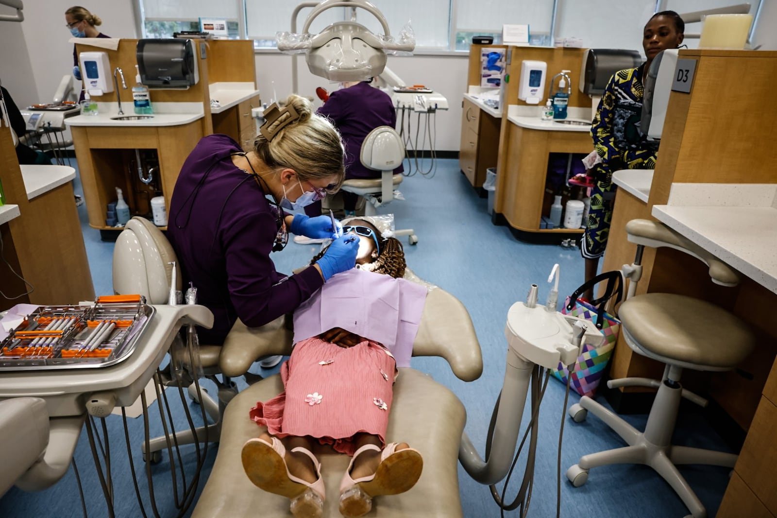 Sinclair Community College dental hygenist student Hunter Class works on a child who is a refugee from the Congo on Monday, June 3, 2024. JIM NOELKER/STAFF