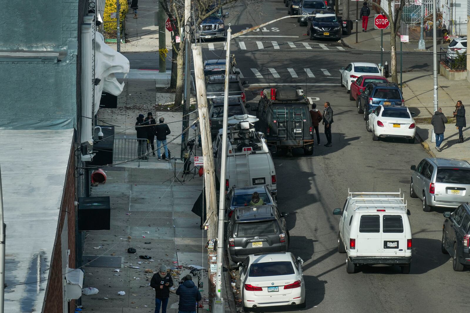 Members of the media work in front of the nightclub Amazura, left, in the Queens borough of New York, Thursday, Jan. 2, 2025. (AP Photo/Seth Wenig)