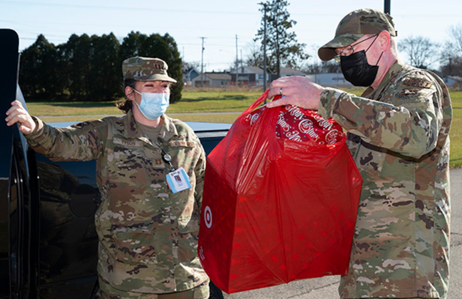 Senior Master Sgt. Timothy Sigafoos, National Air and Space Intelligence Center first sergeant, receives donated gifts from Capt. Chelsea Tyson, 88th Medical Group, for the First Sergeants Council’s Adopt-A-Family Program on Dec. 3 at Wright-Patterson Air Force Base. U.S. AIR FORCE PHOTO/R.J. ORIEZ