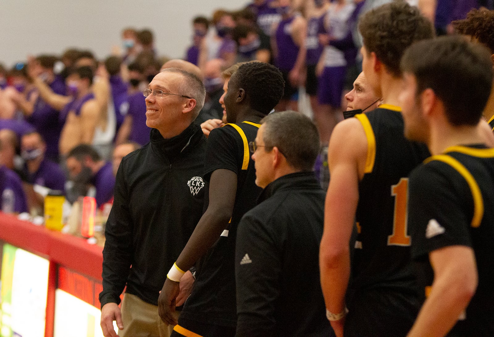 Centerville coach Brook Cupps smiles as he and his team watch the final seconds tick off the clock in Wednesday night's Division I region semifinal at Princeton High School. The Elks defeated Elder 52-43. Jeff Gilbert/CONTRIBUTED