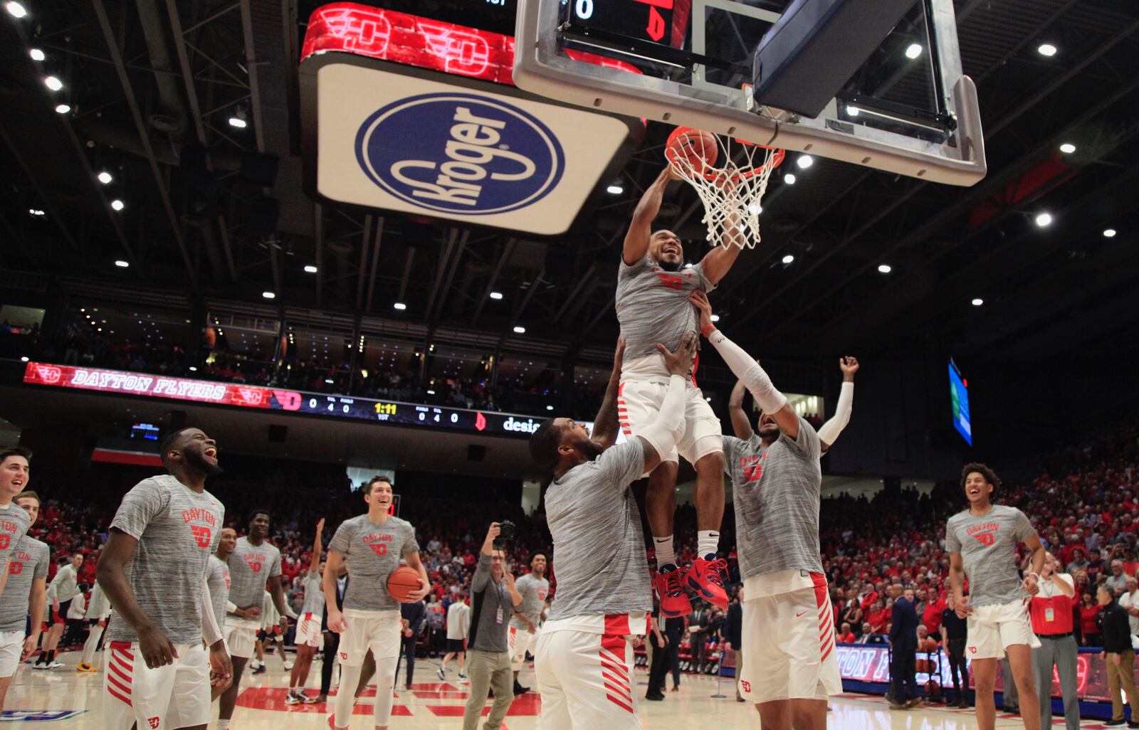 Dayton’s Trey Landers and Obi Toppin help Camron Greer attempt a dunk before a game against Duquesne on Saturday, Feb. 22, 2020, at UD Arena.