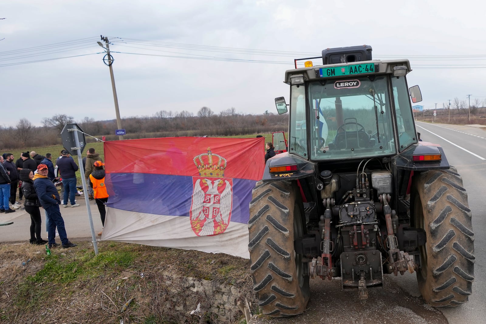 Locals wait for students march near the village of Cerovac near the Serbian industrial town of Kragujevac, to protest the deaths of 15 people killed in the November collapse of a train station canopy, Friday, Feb. 14, 2025. (AP Photo/Darko Vojinovic)