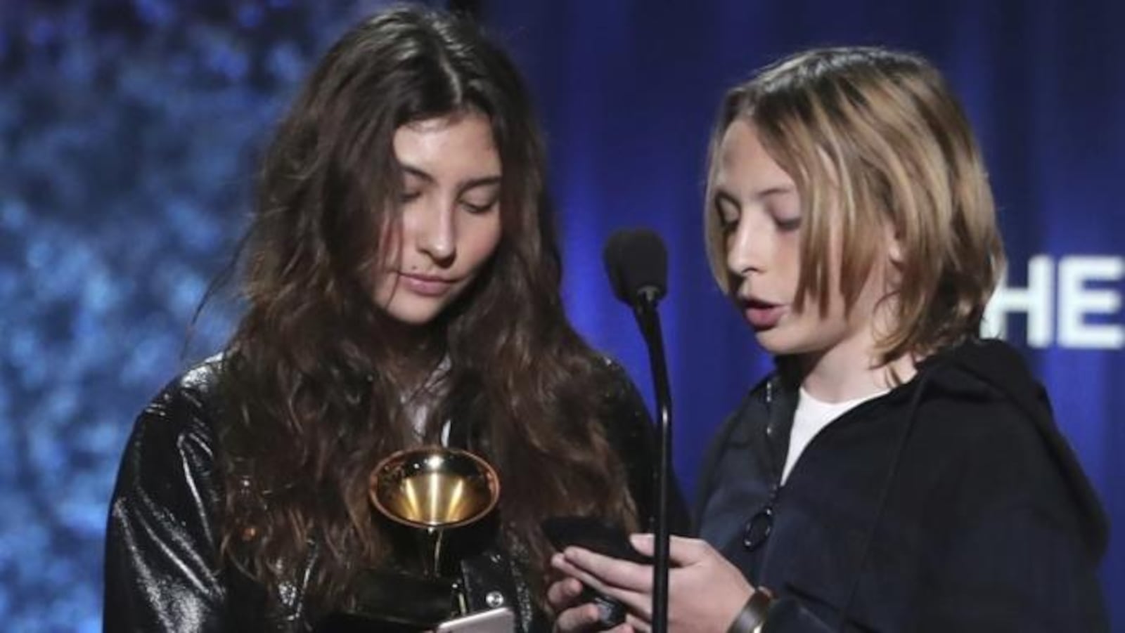 Toni Cornell, from left, Christopher Nicholas Cornell, the children of late rocker Chris Cornell, accept a Grammy on his behalf.