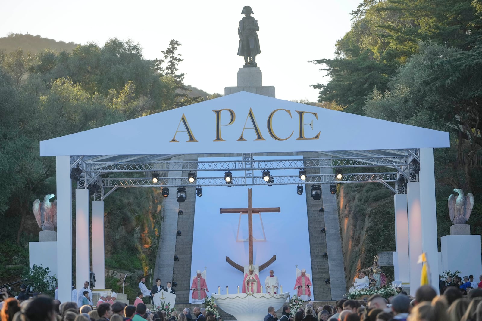 The statue of Napoleon towers Ajaccio "Place d'Austerlitz" as Pope Francis presides over a mass in during his visit in the French island of Corsica, Sunday, Dec. 15, 2024. (AP Photo/Alessandra Tarantino)