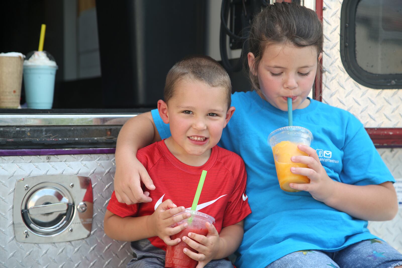 Layton Smiddy and his cousin Harper Heid enjoy smoothies from The Family Bean Coffee Truck.  The Family Bean Coffee Truck was founded by Rhonda Hart and her daughters Courtney Smiddy and Tara Heid. The gourmet coffee truck is known for specialty coffees, cold brews, smoothies, frappes and more. LISA POWELL / STAFF. LISA POWELL / STAFF